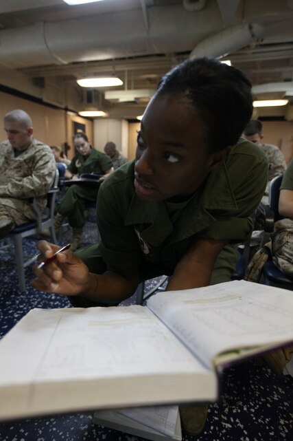 Sergeant Kadian Burns with Marine Medium Tiltrotor Squadron 266 (Reinforced), 26th Marine Expeditionary Unit, studies equations from a book during a math class conducted through Park University aboard USS Kearsarge in the U.S. Navy Fifth Fleet Area of Operation, Sept. 24, 2010. 26th MEU continues to support relief operations in Pakistan and is also serving as the theater reserve force as elements of the MEU conduct training and planned exercises.
