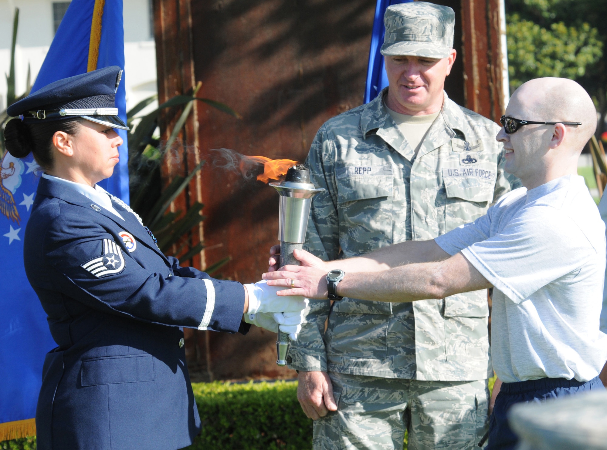 A member of the base honor guard hands the torch to the first runner to kick off the torch realy at Fort MacArthur, Sept 16. The 24- hour relay and closing ceremony were held in recognition of National POW/MIA Appreciation Day, a time to remember those who were prisoners of war and those still missing in action. (Photo by Joe Juarez)