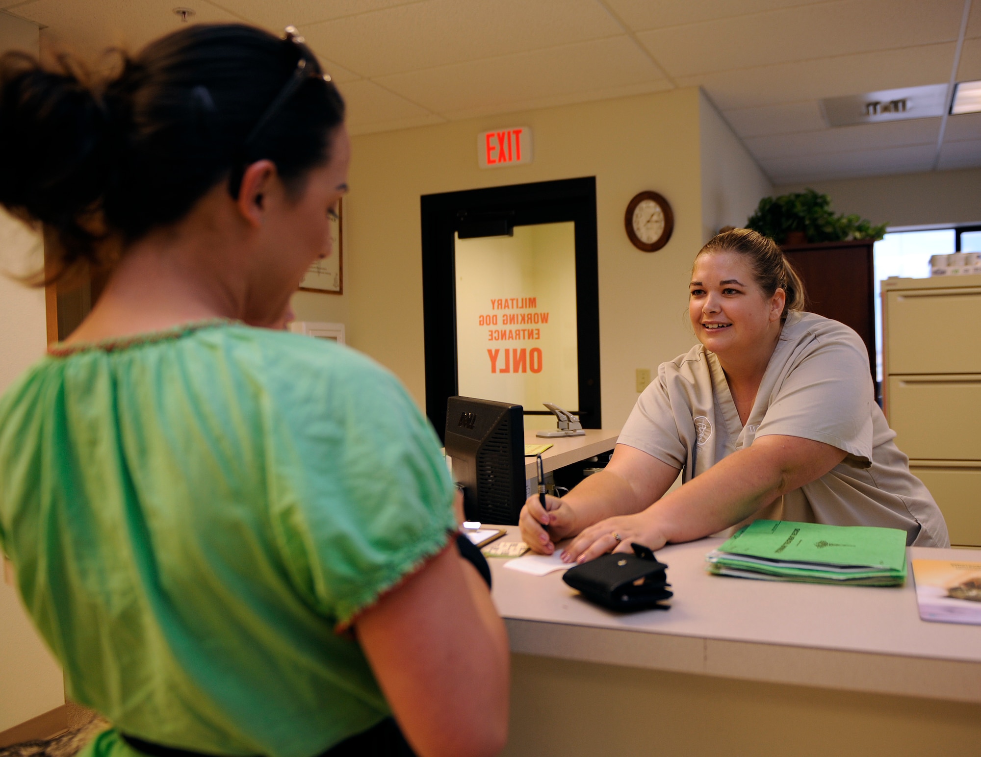 MOUNTAIN HOME AIR FORCE BASE, Idaho -- Tracy Bullock, vet clerk, helps a patient fill out paper work Sept. 16. The Veterinary Treatment Facility is part of the Force Support Squadron which enhances combat readiness, retention and morale through programs promoting well-being and quality of life for the 366th Fighter Wing and its personnel and dependents. The 366th FSS is responsible for dining, lodging, fitness, honor guard, family member programs, leisure activities and mortuary affairs. (U.S. Air Force photo by Senior Airman Renishia Richardson)