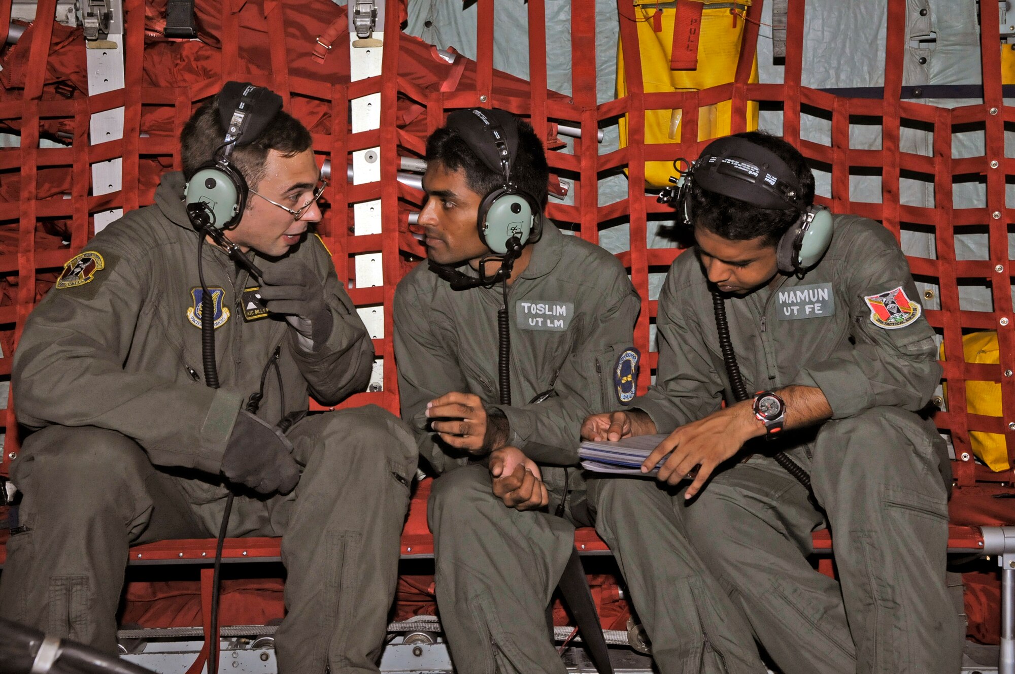Airman 1st Class William Mehalick talks to Leading Aircraftsman Toslim, a Bangladesh loadmaster, and Corp. Mamun, a flight engineer, about in-flight procedures during a flight to Sylhet, Bangladesh, on a U.S. C-130 Hercules aircraft during exercise Cope South 10, Sept. 22, 2010, in Bangladesh. The bilateral exercise's subject-matter expert exchanges in maintenance, operations and rigging disciplines strengthen the strong and growing partnership between the United States and Bangladesh. Two C-130s from Yokota Air Base, Japan, and an AN-32 from Kurmitola Air Base participated in Cope South 10. Airman Mehalick is a loadmaster from the 36th Airlift Squadron at Yokota Air Base, Japan. (U.S. Air Force photo/Master Sgt. Jeff Loftin) 