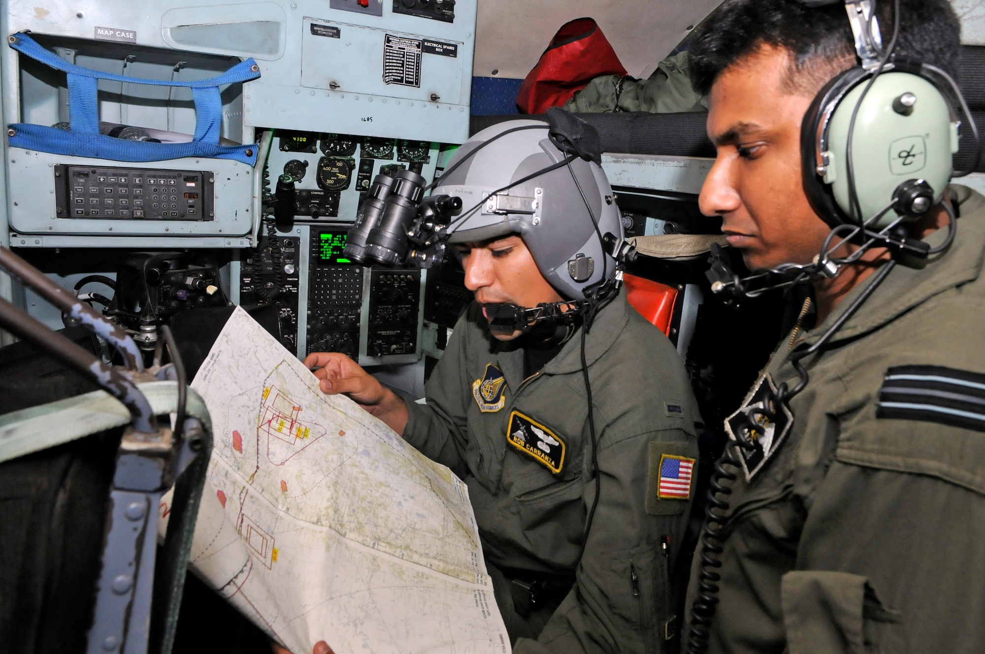 First Lt. Robert Carranza goes over route points with Bangladesh Flt. Lt. Salem, a co-pilot, during a flight to Sylhet, Bangladesh, during exercise Cope South 10, Sept. 22, 2010 in Bangladesh. The bilateral exercise's subject-matter expert exchanges in maintenance, operations and rigging disciplines strengthen the strong and growing partnership between the United States and Bangladesh. Two C-130s from Yokota Air Base, Japan, and an AN-32 from Kurmitola Air Base participated in Cope South 10. Lieutenant Carranza is a navigator from the 36th Airlift Squadron at Yokota Air Base, Japan. (U.S. Air Force photo/Master Sgt. Jeff Loftin)