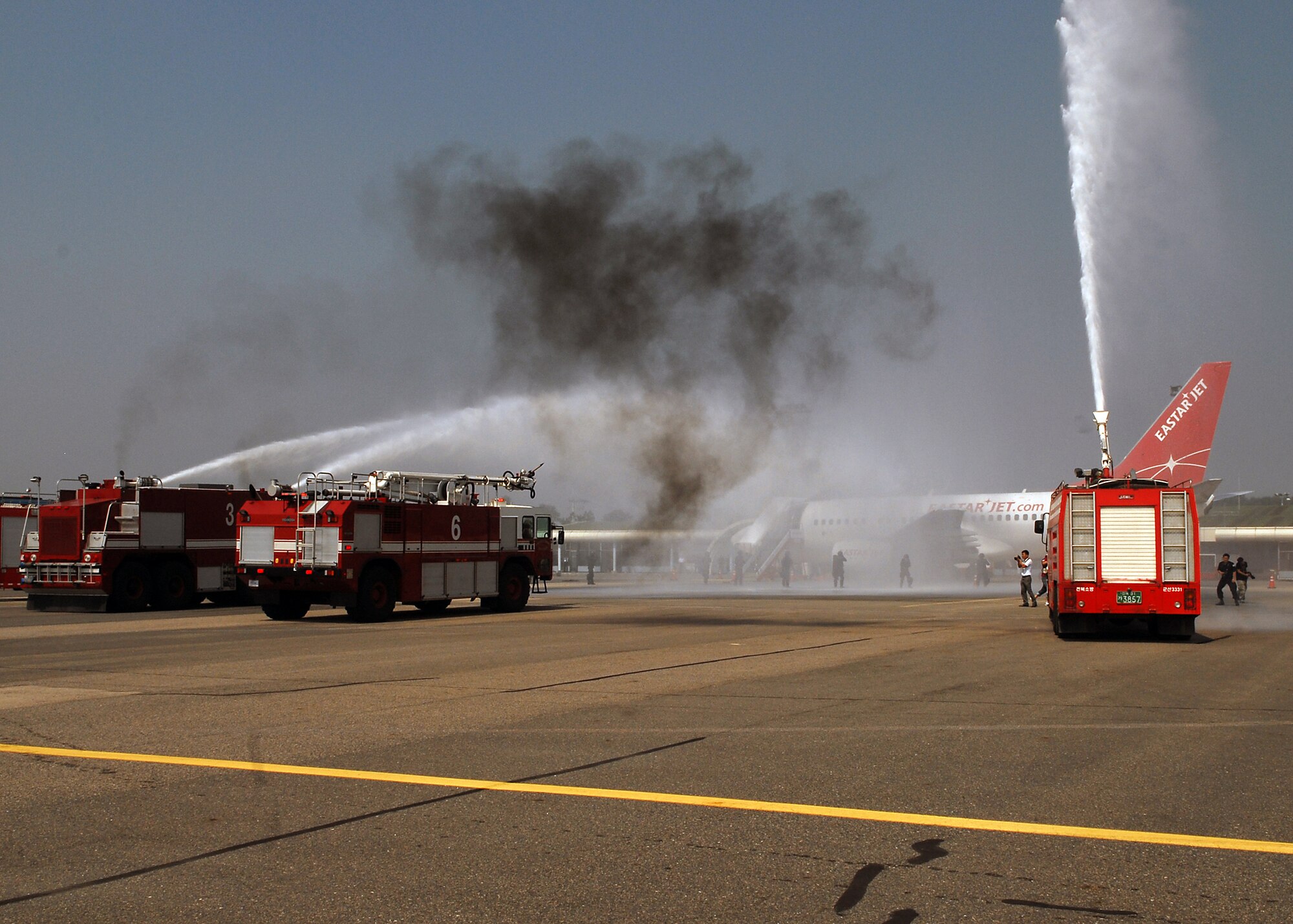 Members of the 8th Civil Engineer Squadron and South Korean fire departments extinguish a simulated burning aircraft as part of an exercise at the Gunsan airport Sept. 17, 2010, at Kunsan Air Base, South Korea. The exercise is conducted annually to enhance counterterrorism and prepare emergency responders for real-life situations. (U.S. Air Force photo/Senior Airman Ciara Wymbs)