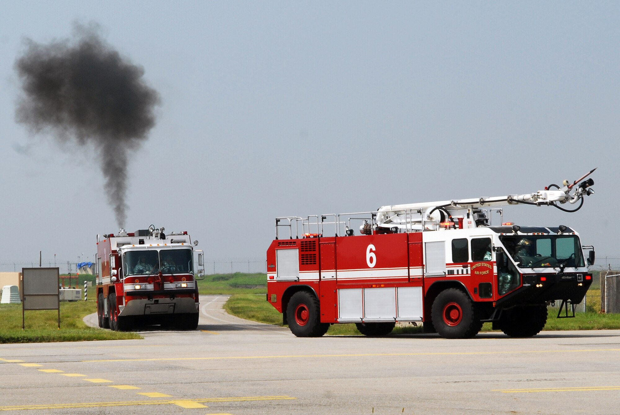 Members of the 8th Civil Engineer Squadron and South Korean fire departments respond to a simulated hostage exercise at the Gunsan airport Sept. 17, 2010, at Kunsan Air Base, South Korea. The exercise is conducted annually to enhance counterterrorism and prepare emergency responders for real-life situations. (U.S. Air Force photo/Senior Airman Ciara Wymbs) 