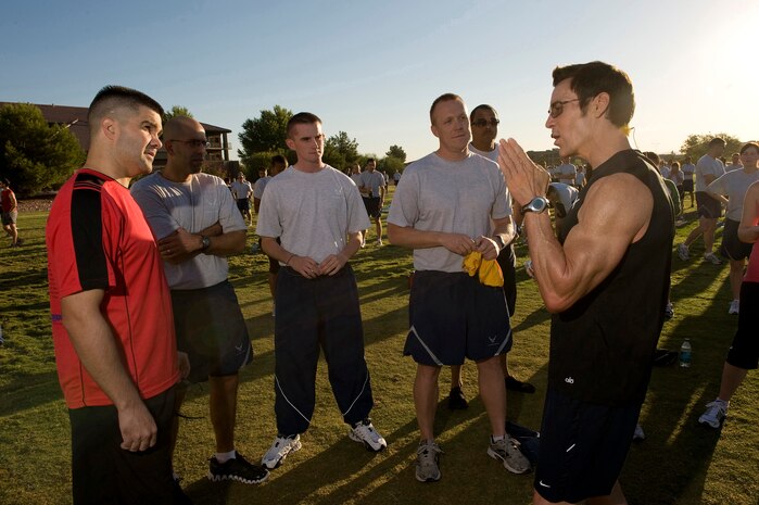 NELLIS AIR FORCE BASE, Nev.-- Fitness trainer Tony Horton (right), talks to Airmen about stories of his physical fitness history at the Nellis Sports Pavilion, Sept. 24. Mr. Horton developed a fitness system which is used by military members from around the world. (U.S. Air Force photo by Senior Airman Brett Clashman/Released)