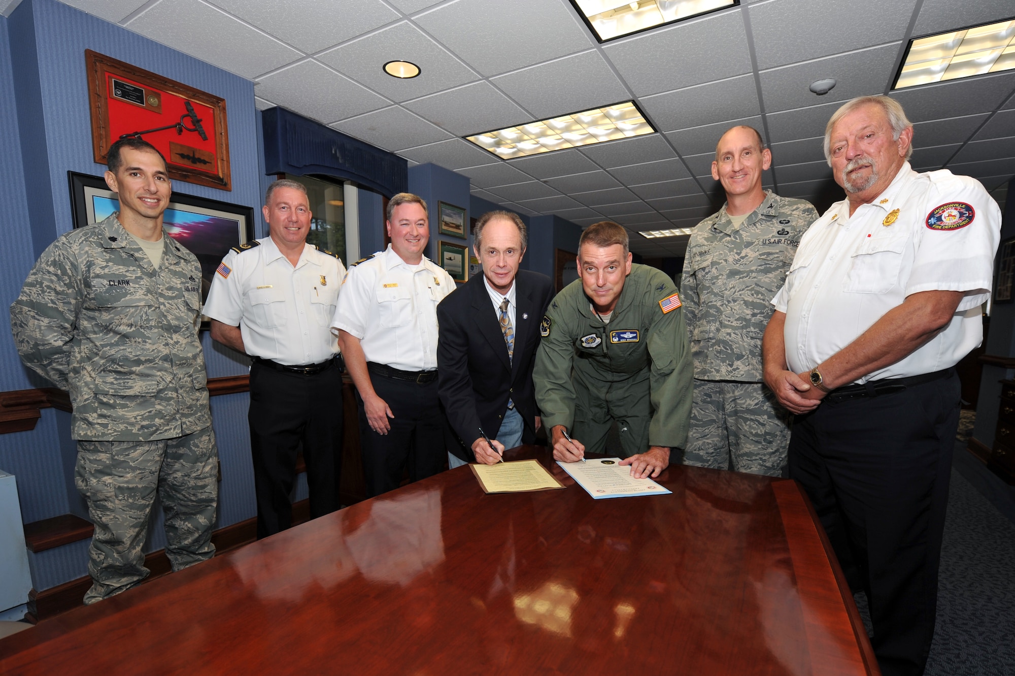 Jacksonville Mayor Gary Fletcher and Col. Mike Minihan, 19th Airlift Wing commander, sign the Fire Prevention Week Proclamation Sept. 24, along with other Team Little Rock leaders and members of the local fire departments. National Fire Prevention Week is held each year on the anniversary of the Great Chicago Fire of 1871 that raged Oct. 8 to 10 and killed more than 250 people, left 100,000 homeless, and destroyed more than 17,400 buildings.  (U.S. Air Force photo by Staff Sgt. Chris Willis)