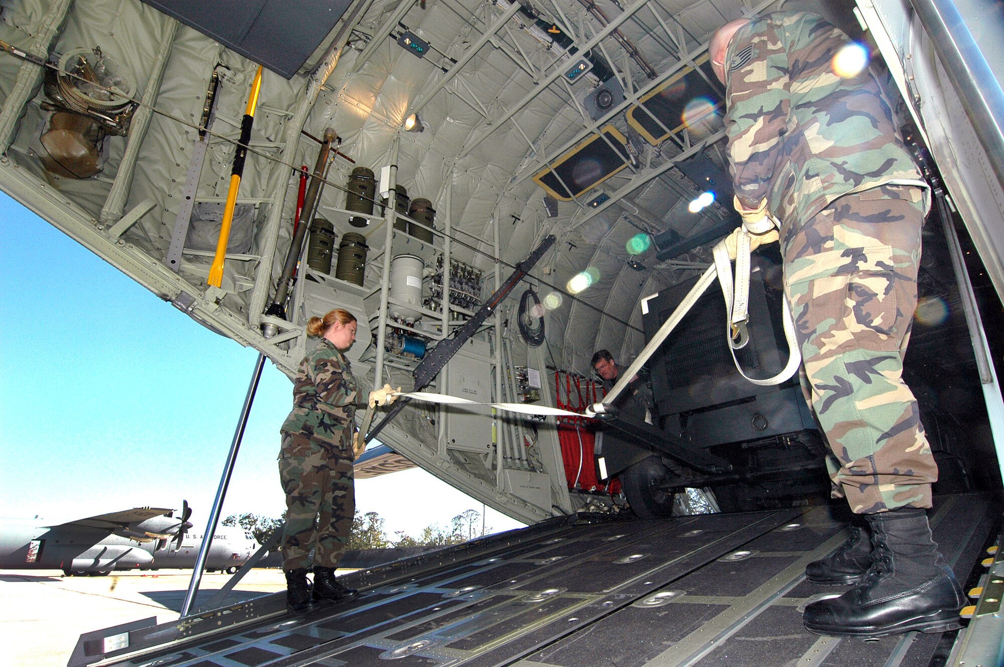 Reservists from the 41st Aerial Port unload a 5,000 pound generator from a C-130J Hercules. The aircraft returned home after flying missions out of Dobbins Air Reserve Base, Ga., since Hurricane Katrina bashed apart its home base. Defense officials are working to determine the role going forward for the nation's reserve-component forces (U.S. Air Force photo/Tech. Sgt. Chance Babin)