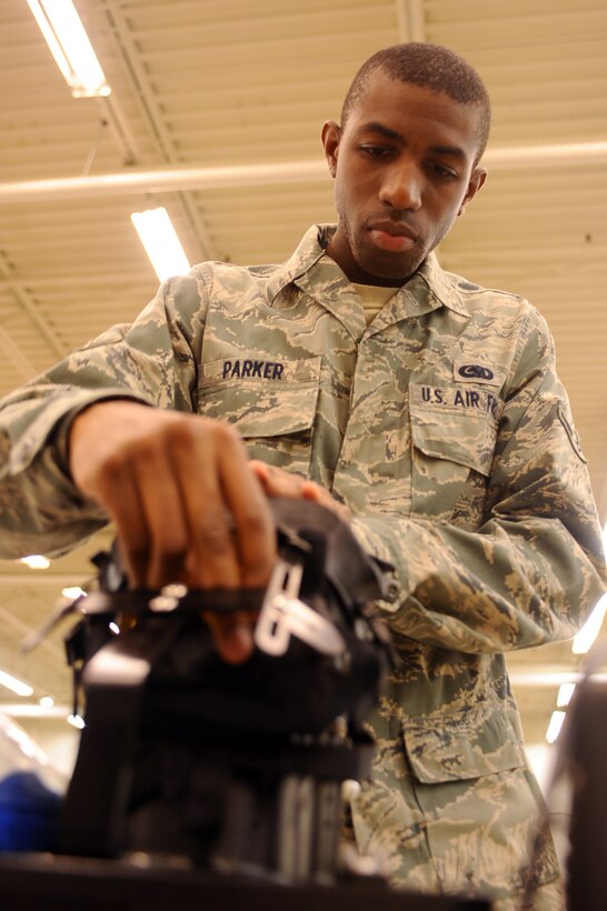 ELLSWORTH AFB, S.D. - Airman Dameon Parker, 28th Logistics Readiness Squadron individual protection equipment augmentee, secures an M-50 gas mask to a Joint Service Mask Leakage Tester as part of a routine inspection, Sept. 22. Airman Parker tested the mask to ensure it is impermeable to toxins. (U.S. Air Force photo/Senior Airman Kasey Close)