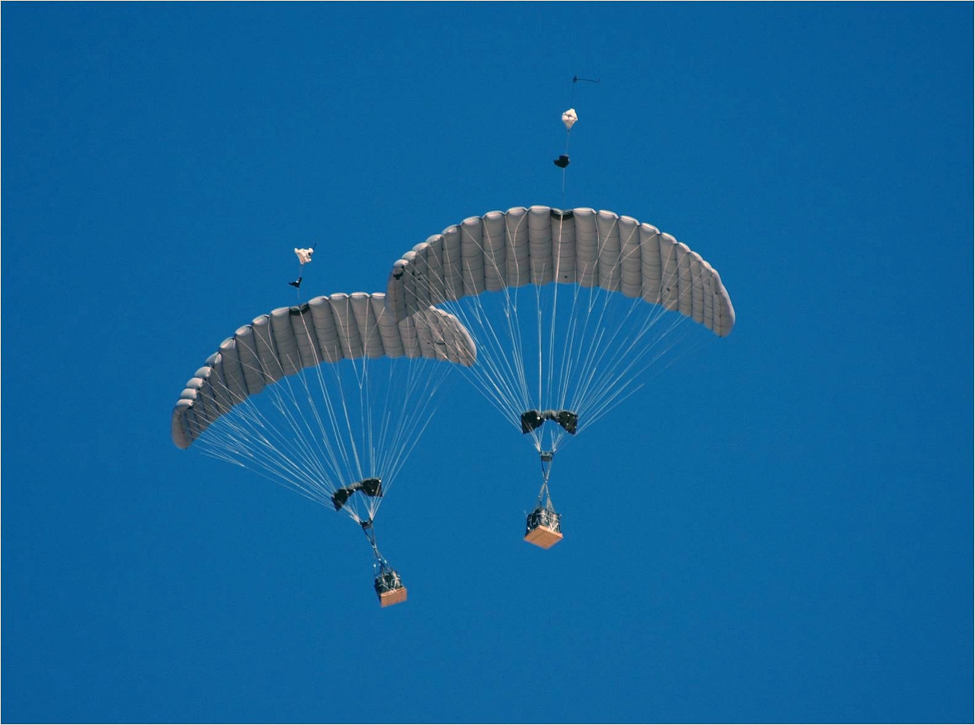 The guided payload 2,200 pound weight class of the Joint Precision Airdrop System in flight during its first combat airdrop. A joint Air Force, Army and contract team recently corrected an accuracy issue with this variant of JPADS. (Courtesy photo)