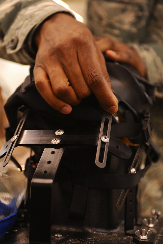 ELLSWORTH AFB, S.D. - Airman Dameon Parker, 28th Logistics Readiness Squadron individual protection equipment augmentee, attaches an M-50 gas mask to a Joint Service Mask Leakage Tester as part of a routine inspection, Sept. 22. The test ensures the mask has a good seal. (U.S. Air Force photo/Senior Airman Kasey Close)