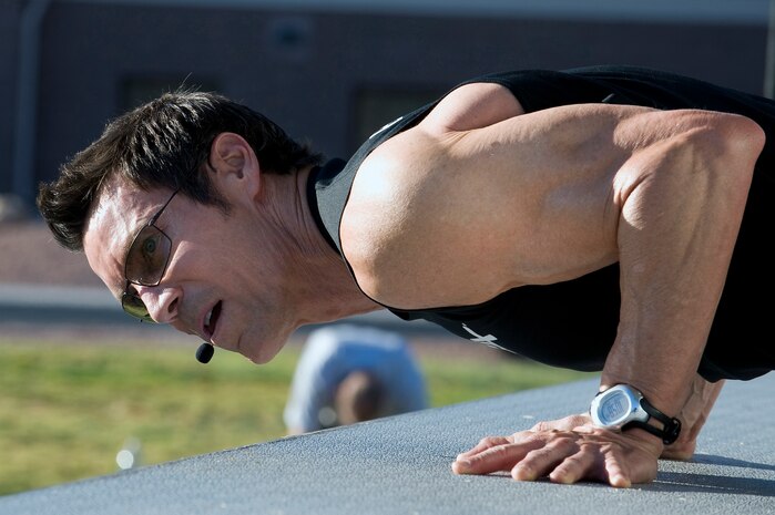 NELLIS AIR FORCE BASE, Nev.-- Fitness trainer Tony Horton conducts a push-up exercise at the Nellis Sports Pavilion, Sept. 24. Mr. Horton developed a fitness system which is used by military members from around the world. (U.S. Air Force photo by Senior Airman Brett Clashman/Released)