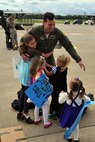 YOUNGSTOWN AIR RESERVE STATION, Ohio -- Air Force Reserve 1st Lt. Phillip Bledsoe, an aircrew member assigned to the 773rd Airlift Squadron, hugs his four daughters upon his return here, September 17, following a 120-deployment to Ramsteain Air Base, Germany. Lieutenant Bledsoe was one of approximately 60 Citizen Airmen, including  aircrews and maintenance personnel from 910th Airlift Wing, providing airlift support for U.S. Africa Command. U.S. Air Force photo by Master Sgt. Bob Barko Jr.