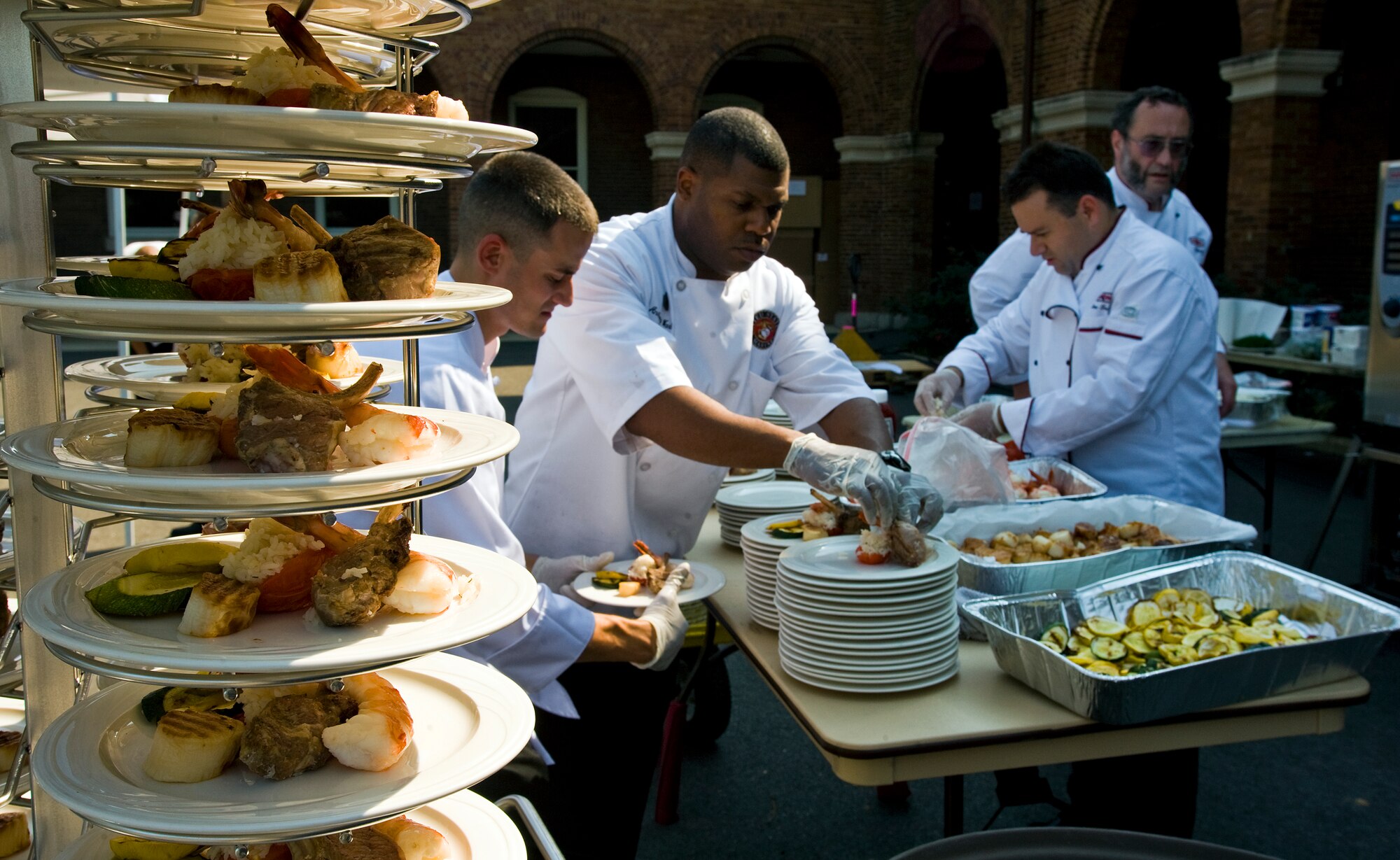 Military food service specialists prepare plates for a kick-off luncheon at the 7th Annual Military Culinary Competition Sept. 24, 2010, in Washington, DC. (U.S. Air Force photo/Tech. Sgt. Bennie J. Davis III)
