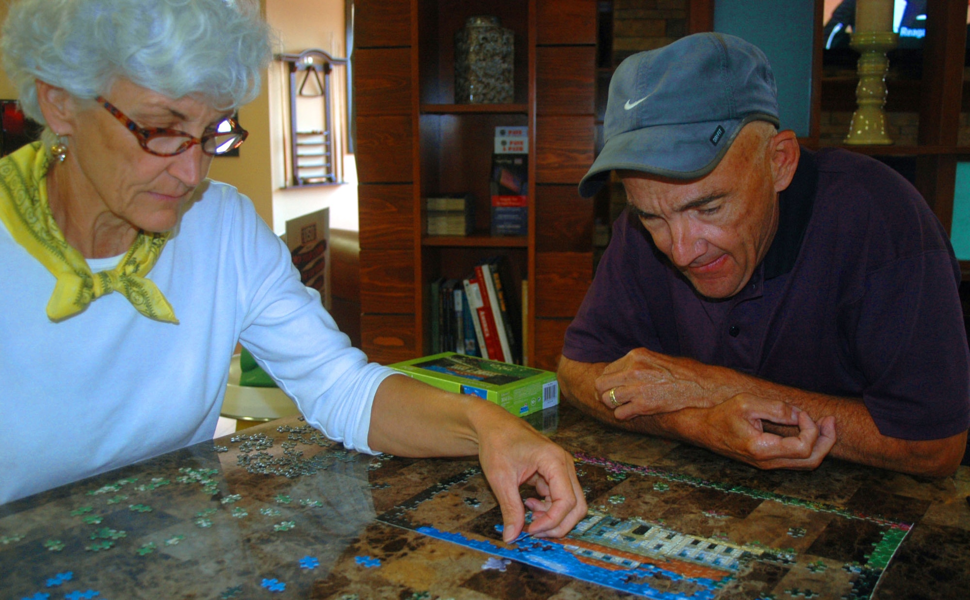 U.S. Air Force retired Col. Bob Mitchell and his wife, U.S. Air Force retired Lt. Col. Susan Mitchell, work together on a puzzle Sept. 23 in the USO Community Center on Dover Air Force Base while waiting for transportation to Germany.
