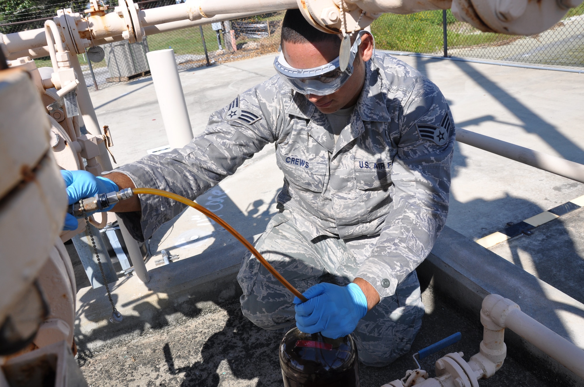 Senior Airman Greg Crews, 1st Special Operatons Logistics Readiness Squadron fuels laboratory technician, collects a sample of fuel at a pump outside the Sound at Hurlburt Field, Fla., Sept. 23, 2010. The 1st SOLRS received neary half a million gallons of jet fuel delivered by the barge for the first time since October 2009. (DoD photo by U.S. Air Force Airman 1st Class Joe McFadden) (RELEASED)