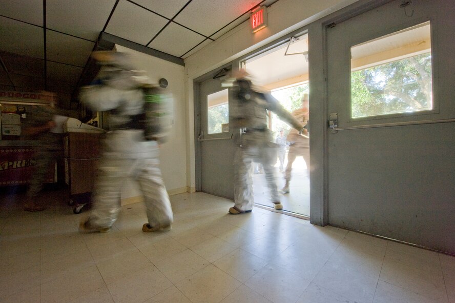 BARKSDALE AIR FORCE BASE, La. -- Firefighters assigned to the 2nd Civil Engineer Squadron rush into the base theater as part of a scenario during a nuclear surety exercise Sept. 24. The NSE is designed to ensure Barksdale's ability to execute nuclear operations in a safe, secure and reliable manner. (U.S. Air Force photo/Senior Airman Chad Warren)