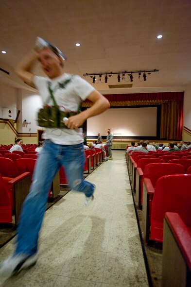BARKSDALE AIR FORCE BASE, La. -- A simulated terrorist runs through the base theater as part of a scenario during a nuclear surety exercise Sept. 24. The NSE is designed to ensure Barksdale's ability to execute nuclear operations in a safe, secure and reliable manner. (U.S. Air Force photo/Senior Airman Chad Warren)