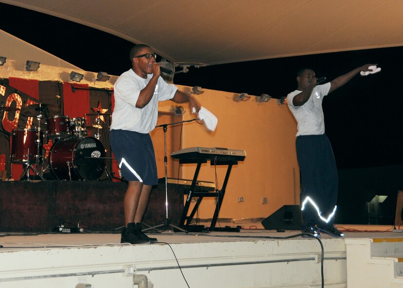 U.S. Air Force Senior Airmen Ronnell Freeman (left) and Ranson Evans (right), 379th Expeditionary Logistics Readiness Squadron, perform during the Got Talent competition at a base in Southwest Asia September 10. Freeman and Evans performed an original song called "Outer Space," and taught audience members a dance they created called "The Rock."  The competition lasted three nights and the duo placed third overall.  Freeman and Evans are deployed from the 131st Bomb Wing, Missouri Air National Guard, Whiteman Air Force Base. (U.S. Air Force photo by Master Sgt. Mary-Dale Amison/Released)