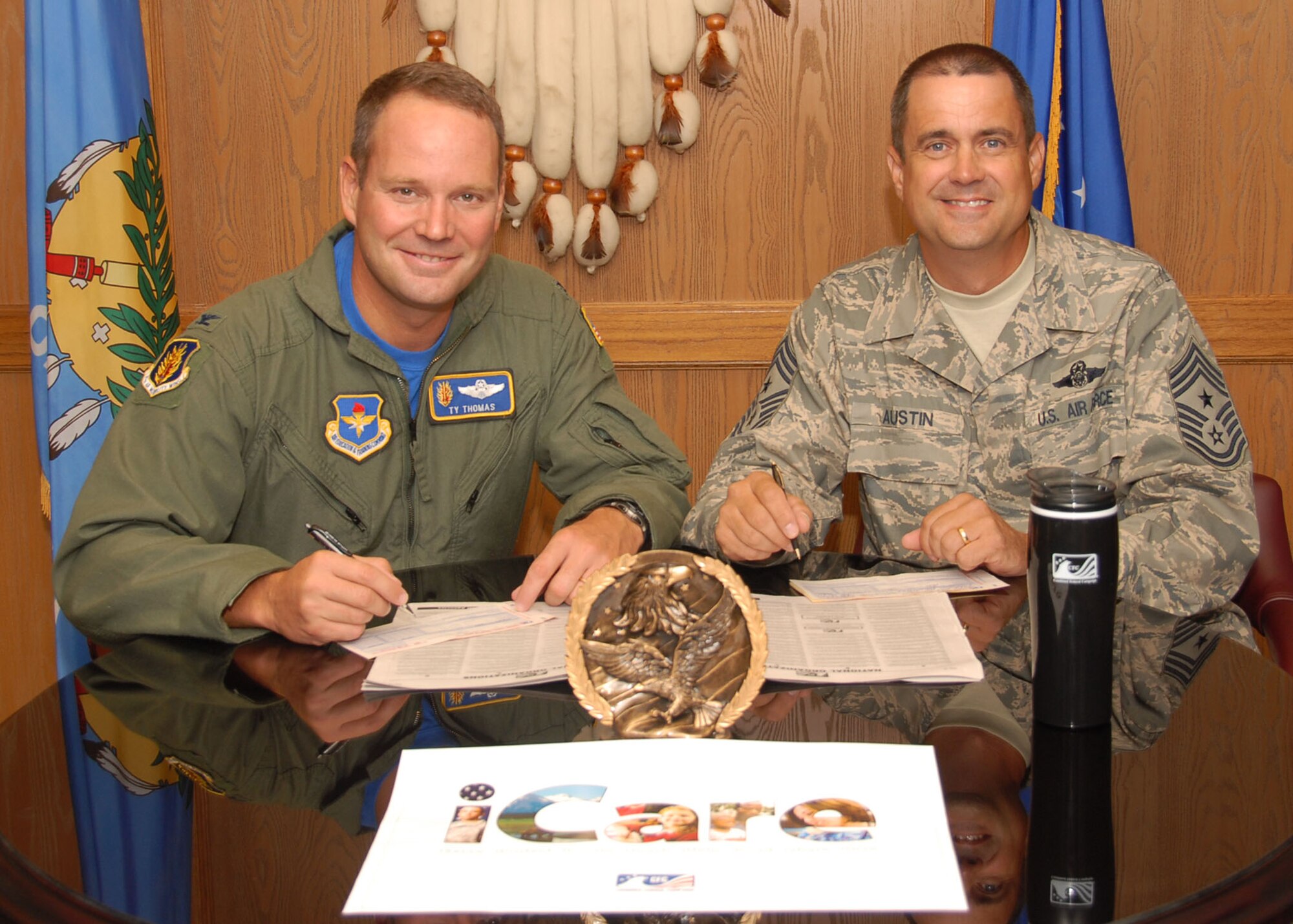 ALTUS AIR FORCE BASE, Okla. – (L to R) Col. Ty Thomas, commander of 97 Air Mobility Wing, and Command Chief Master Sgt. Bob Austin commit to the Combined Federal Campaign Sept. 24. The Combined Federal Campaign is the world’s largest and most successful annual workplace charity campaign, with more than 300 campaigns throughout the country and internationally, helping to raise millions of dollars each year. (U.S. Air Force photo by Airman 1st Class Christopher Arnold/Released 97th Air Mobility Wing – Public Affairs)