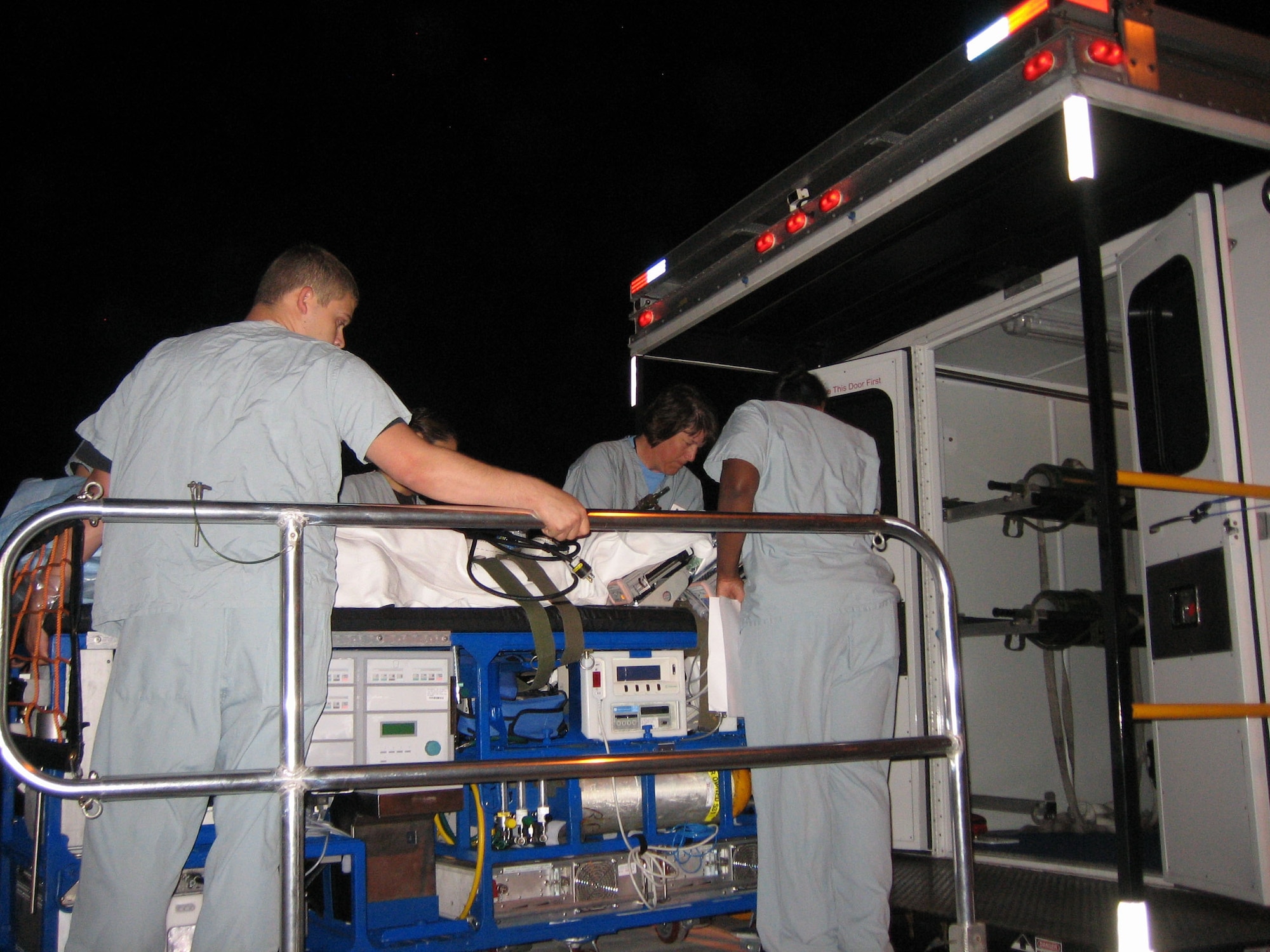 An Extra-Corporeal Membrane Oxygenation team loads a third-generation ECMO cart into an ambulance. The third-generation model is the most current model being used today, and is capable of serving adults. (Courtesy photo/Released)