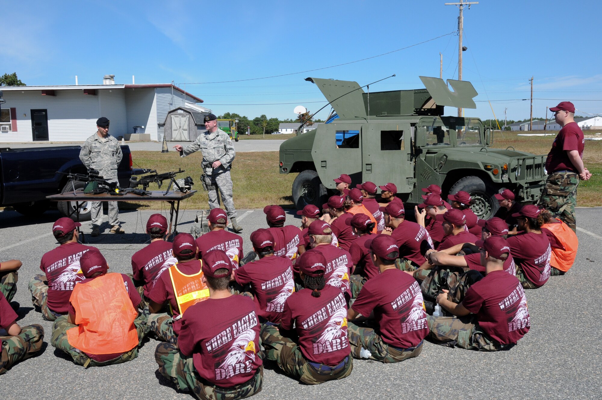 On September 23, 2010, members from the Woonsocket, RI, Junior ROTC program visit Camp Edwards for military demonstrations and drill. Technical Sgt. Sean Dias and Staff Sgt. Edward Rene give a briefing and demonstration on the equipment they use to perform their duties as Security Forces with the 102d Intelligence Wing, Cape Cod, Mass.