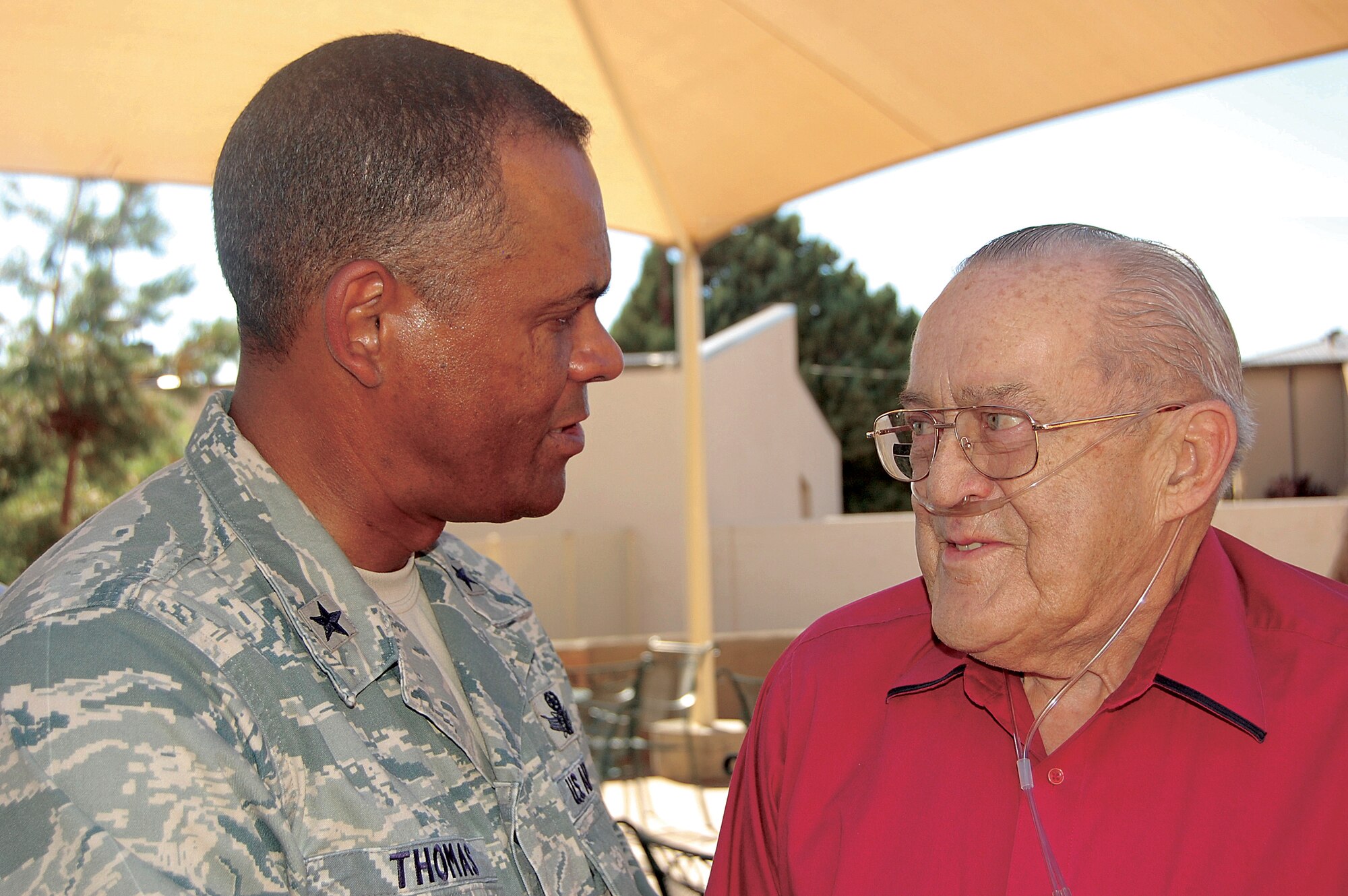 Brig. Gen. Everett Thomas, Air Force Nuclear Weapons Center commander, speaks to retired Lt. Col. Robert E. Campbell, who was stationed here during the transition from the Army Air Corps to the Air Force.  U.S. Air Force Photo by Jonathan Rejent