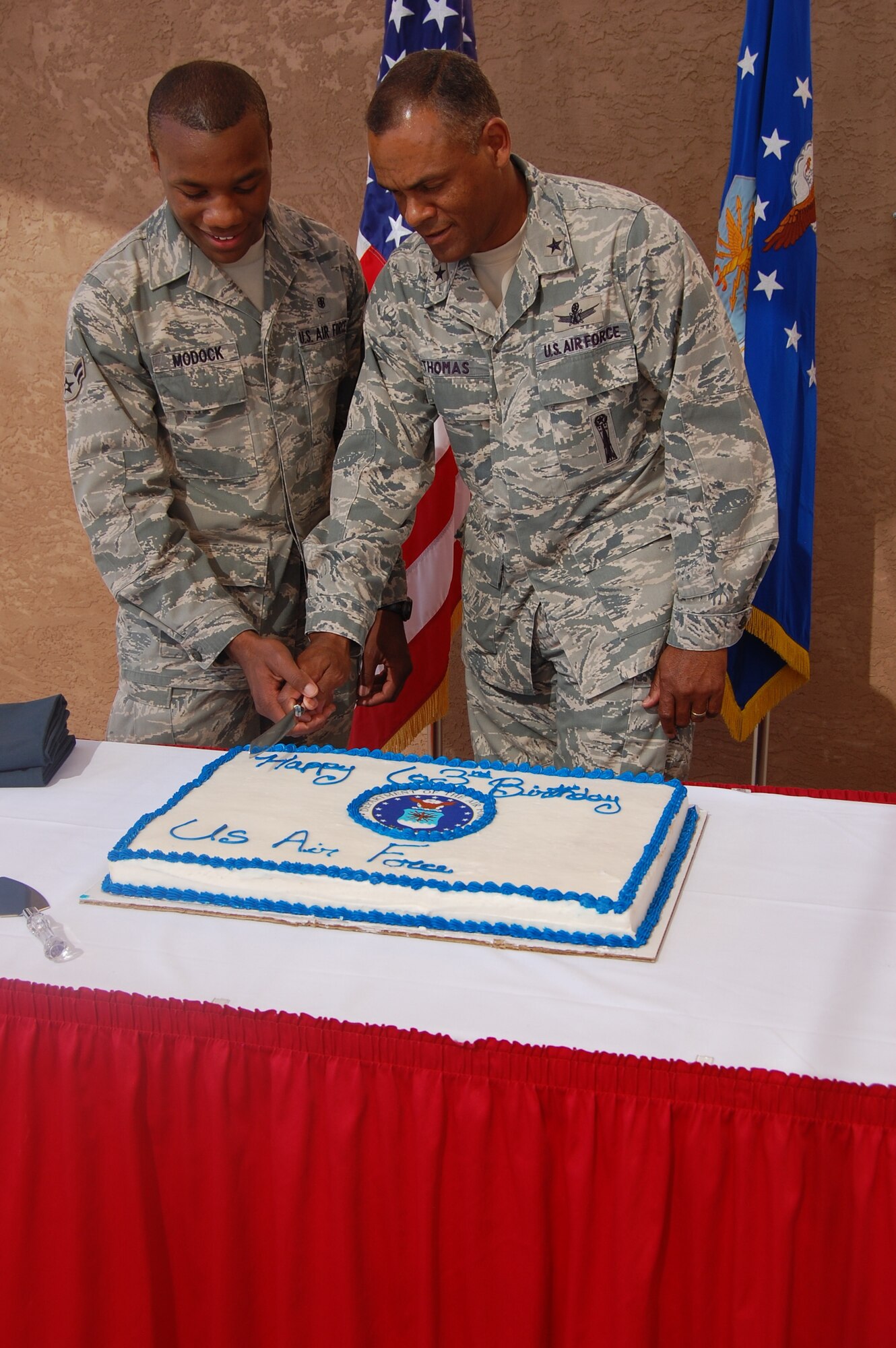 Brig. Gen. Everett Thomas, Air Force Nuclear Weapons Center commander, right, cuts the cake with one of Kirtland AFB’s youngest Airmen, Airman 1st Class Bre’Jon Modock, 377th Medical Operations Squadron, during an Air Force birthday celebration Sept. 17 at the Mountain View Club.  U.S. Air Force Photo by Jonathan Rejent