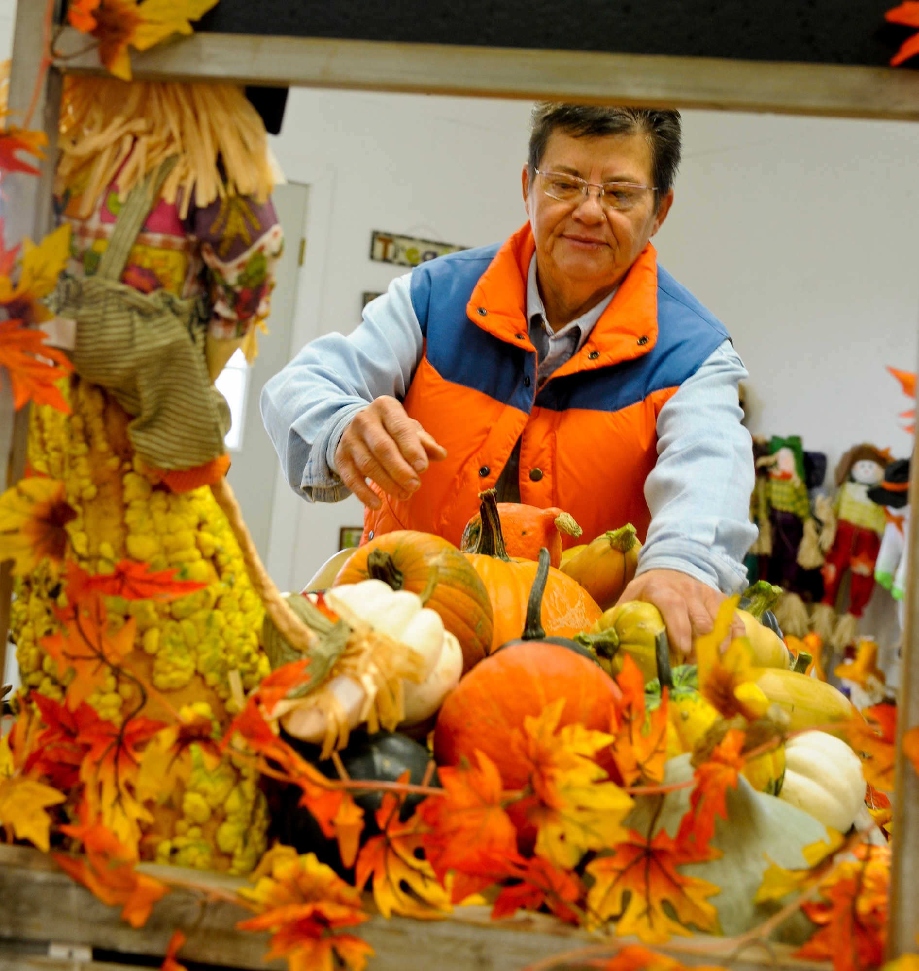 MINOT, N.D. -- Jeanie Storsteen, an employee at the corn maze, arranges gourds inside the store at Berry Acres here Sept. 20. In addition to the 8-acre corn maze, Berry Acres also sells vegetables, fall decorations and locally made baked goods. (U.S. Air Force photo by Laurie Arellano)