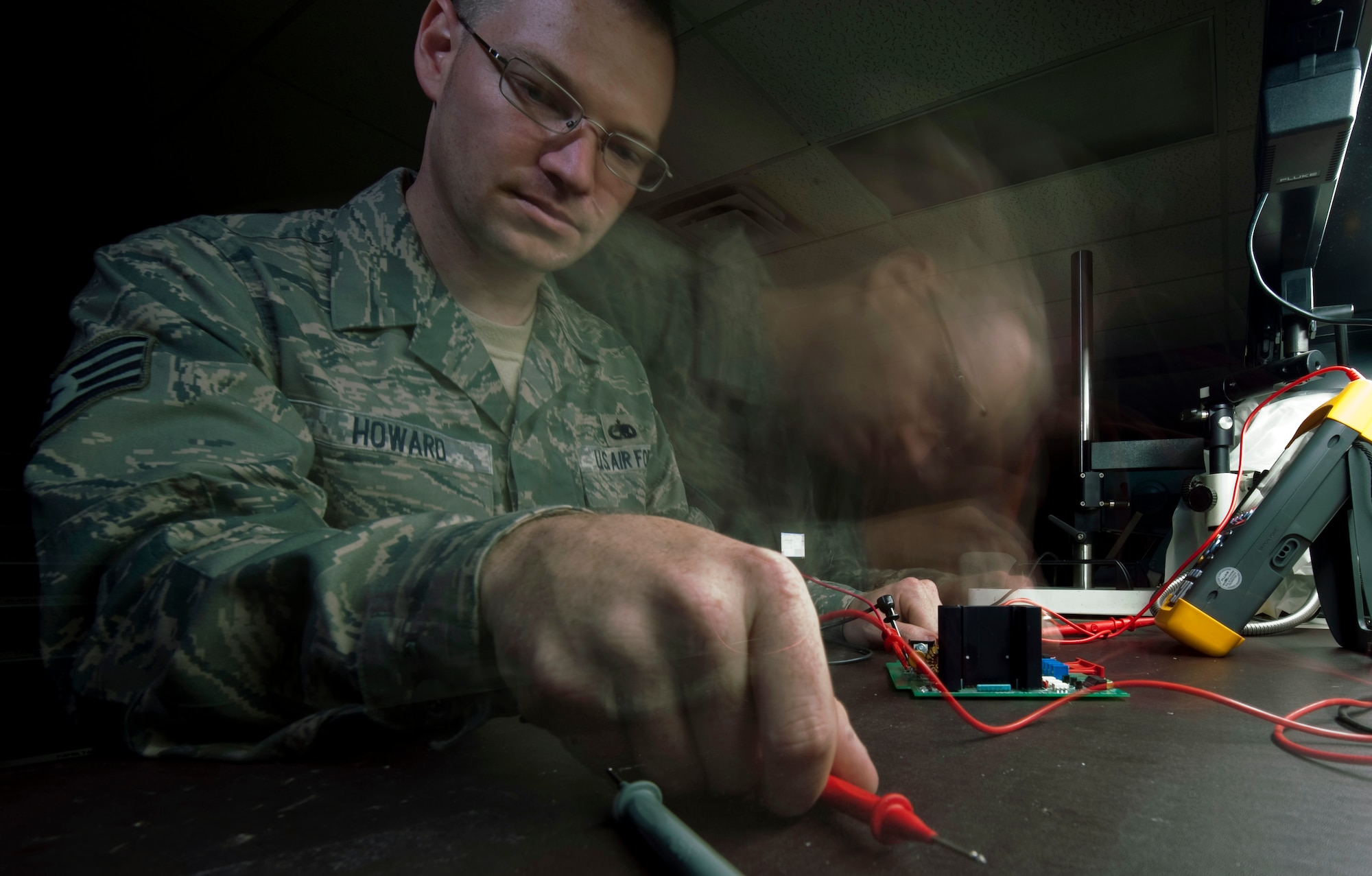 HOLLOMAN AIR FORCE BASE, N.M. -- Staff Sgt. Thomas Howard, 49th Maintenance Group Air Force Repair Enhancement Program, grabs and uses a multi meter to test a component Sept. 21, 2010. The AFREP shop on base repairs otherwise unserviceable equipment and finds innovative ways to improve the 49th Wing repair process. (U.S. Air Force photo by Airman 1st Class Joshua Turner / Released)