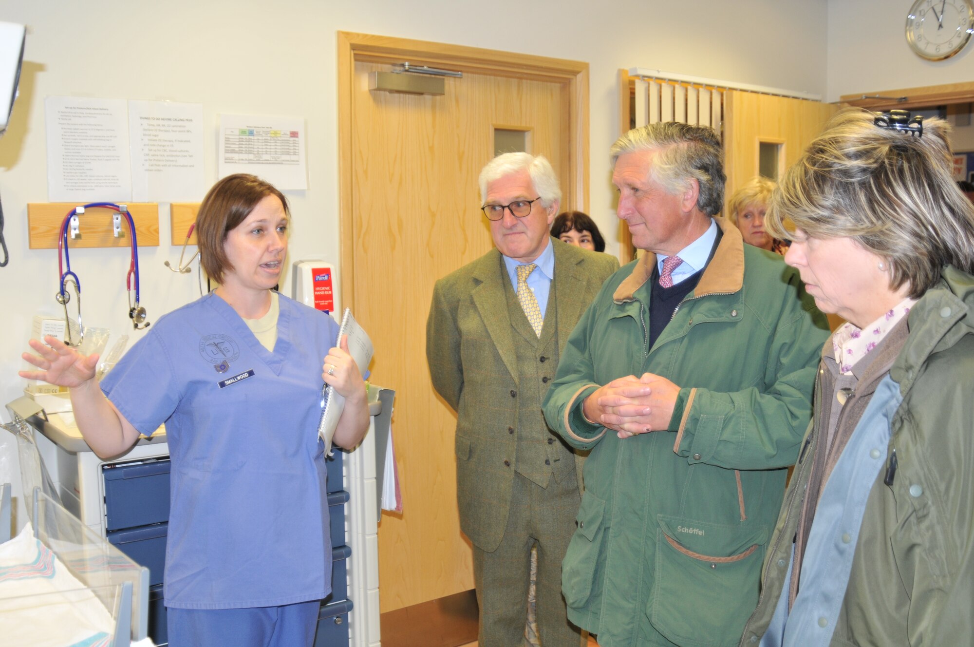 Tech. Sgt. Brandi Smallwood, 48th Inpatient Squadron Labor and Delivery Flight chief, tells High Sheriff of Norfolk Charles Barratt (second from right) about newborn care facilities Sept. 24 at the 48th Medical Group on RAF Lakenheath, England. As high sheriff, Mr. Barratt is the appointed representative of the English sovereign in matters relating to the judiciary and maintenance of law and order. (U.S. Air Force photo/Senior Airman David Dobrydney)
