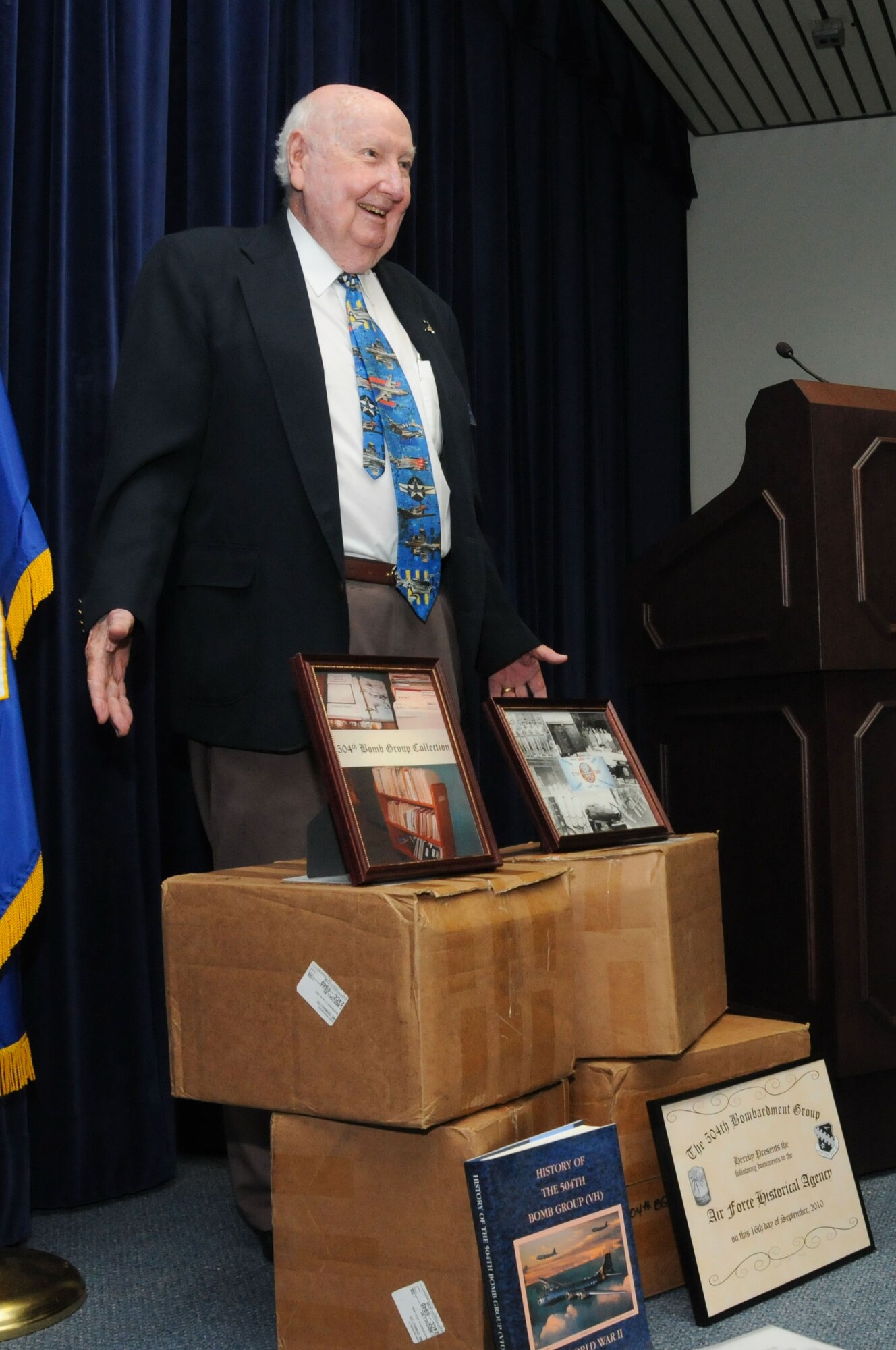 Fiske Hanley, the 504th historian, shows off the boxes of documents and memorabilia the bomb group collected. (Air Force photo/Bennett Rock)