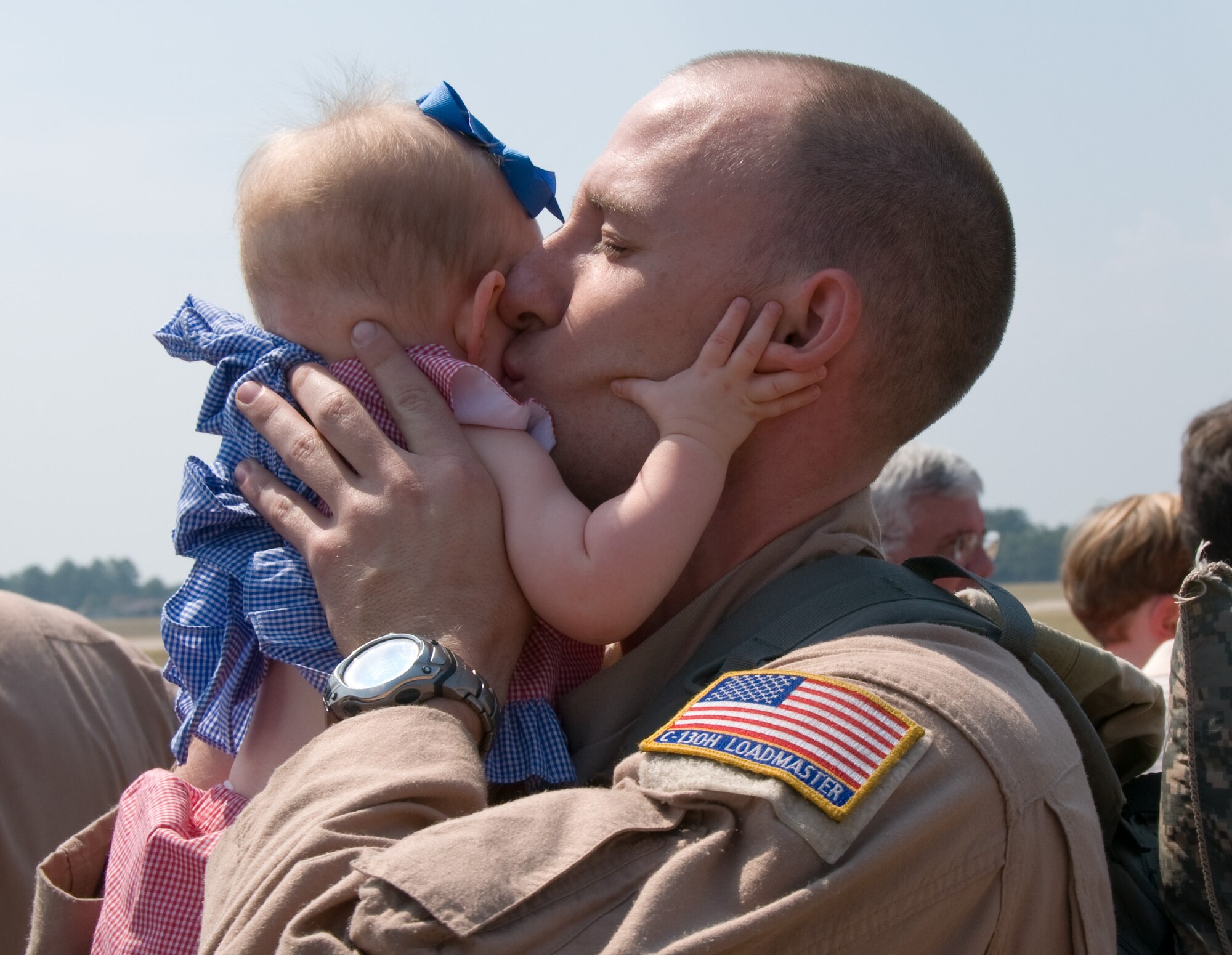 Technical Sgt. Adam Nixon hugs his daughter, Emery, upon his return from a four-month deployment with the 908th Airlift Wing. (Air Force photo/Jamie Pitcher)