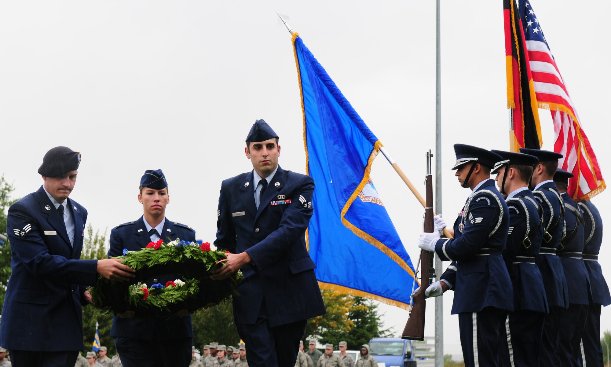 SPANGDAHLEM AIR BASE, Germany – Senior Airman Matthew Sargent, 52nd Security Forces Squadron, left, 2nd Lt. Danielle Ackerman 52nd Component Maintenance Squadron, center, and Senior Airman Sean Heron, 52nd Operation Squadron, carry a wreath past the honor guard Sept. 24. The wreath was laid at the base of a monument during the installation’s prisoner of war missing in action ceremony. (U.S.  Air Force photo/Staff Sgt. Heather M. Norris)