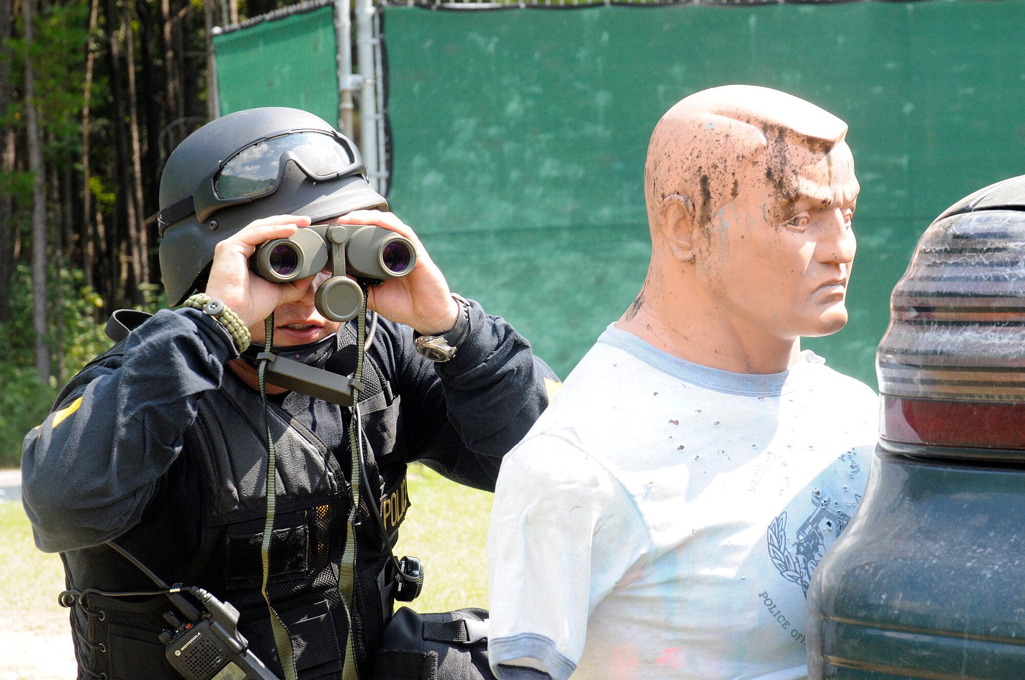 Private 1st Class Scott Derrick attached to the Special Response Team with the Goose Creek Police Department, gathers information on a simulated shooter during an exercise on Naval Weapons Station Charleston Sept. 22, 2010. Goose Creek Police Department police officers played a vital role, displaying their tactical proficiency. The exercise was held as a joint effort between Air Force and Navy personnel to build the working relationship between both services operating as one team on Joint Base Charleston. (U.S. Navy photo/Mass Communication Specialist 1st Class Jennifer R. Hudson/released)