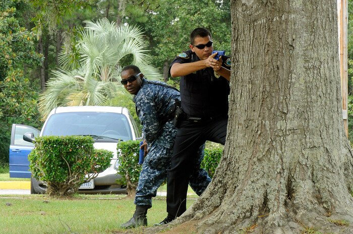 Patrolman Benjamin Mcswain, right, from Gastonia, NC, and partner Master-at-Arms 2nd Class Sherman Widbee from Richmond, Va., respond as the first on scene during a base-wide active shooter exercise on Naval Weapons Station Charleston Sept. 22, 2010. Both Patrolman Mcswain and Master-at-Arms Widbee are with the Naval Weapons Station Charleston security department. (U.S. Navy photo/Mass Communication Specialist 1st Class Jennifer R. Hudson/released)