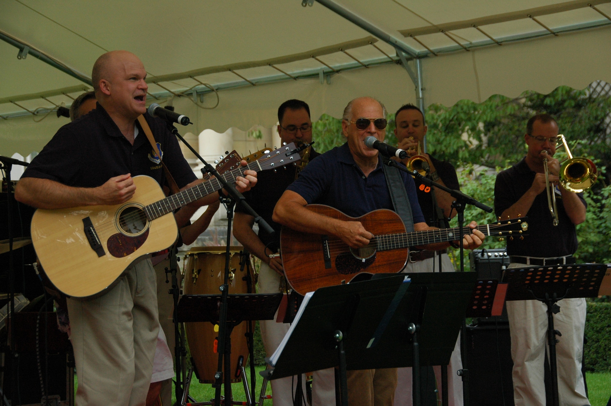 PARIS -- Grammy award winning recording artist Jimmy Buffett (center front) performs members of the U.S. Air Forces in Europe Band "Direct Hit" at the U.S. Embassy-Paris Sept. 23, 2010. Direct Hit provided entertainment support to the embassy for its annual Rentree Barbecue. Mr. Buffett was a guest of honor at the event and also performed some of his hits with the USAFE Band. (U.S. Air Force photo/Staff Sgt. Craig Bowman)