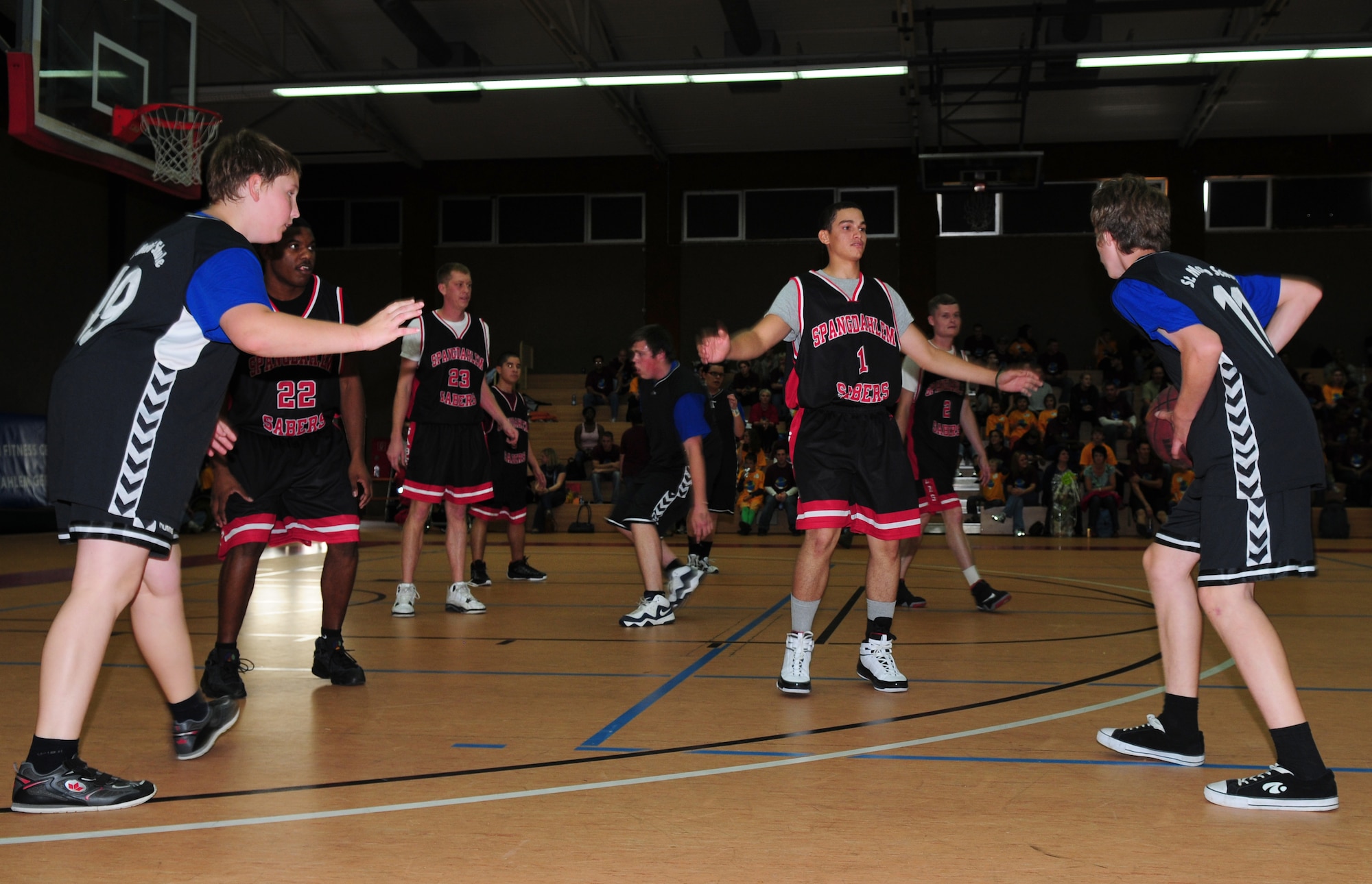 SPANGDAHLEM AIR BASE, Germany – Spectators look on as the Spangdahlem men’s basketball team compete against the St Martin’s Schule basketball team during the 15th annual St. Martin’s Special Children’s Day Sept. 23.  Approximately 100 children participated in sporting events, song demonstrations, a basketball game and a cookout as part of the event aimed at fun for the children and strengthening community relationships.  (U.S.  Air Force photo/Staff Sgt. Heather M. Norris)