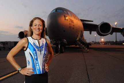 U.S. Air Force Capt. Jamie Turner, wearing her Air Force Ironman uniform, stands in front of a C-17 Globemaster III on Joint Base Charleston, S.C., Sept. 21, 2010. Captain Turner is training to swim 2.4-miles through ocean waves, bike 112 miles and run a 26.2-mile marathon through challenging lava-covered terrain. Selected as one of 1,800 Ironman World Championship competitors, she will test her endurance in one of the top athletic challenges the sports world has to offer. Captain Turner is a pilot with the 315th Airlift Wing. (U.S. Air Force photo/James M. Bowman)