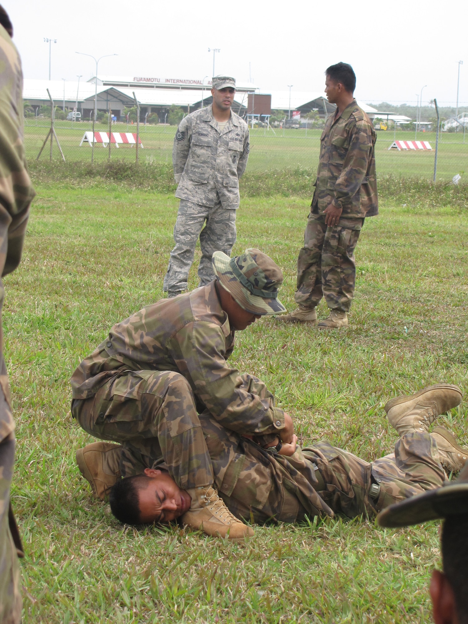 Tongan Defense Force members demonstrate tactical maneuvers for Tech. Sgt. Marcus Serrano, a cadre instructor from the 736th Security Forces Squadron’s Commando Warrior Regional Training Center at Andersen Air Force, Guam, during a U.S. and Tongan Subject-Matter Expert Exchange in Nuku’alofa, Kingdom of Tonga, on Sept. 14, 2010. The SMEE, which focused on tactical-team combat maneuvers, allowed U.S. and Tongan forces to share force protection and security operations information and understanding among attendees. (U.S. Air Force photo/ Francis Deniz)