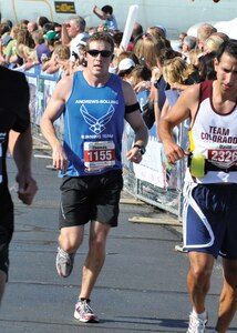 JOINT BASE ANDREWS, Md. -- First Lt. Thomas Hanson, center, 316th Civil Engineer Squadron Operations Support Squadron officer in charge, crosses the finish line with a run time of 3:14:38 at the Air Force Marathon in Wright Patterson Air Force Base, Ohio, Sept. 18. He was the lead performer for ‘Team Andrews.’ (U.S. Air Force photo by Staff Sgt. Christopher Marasky)