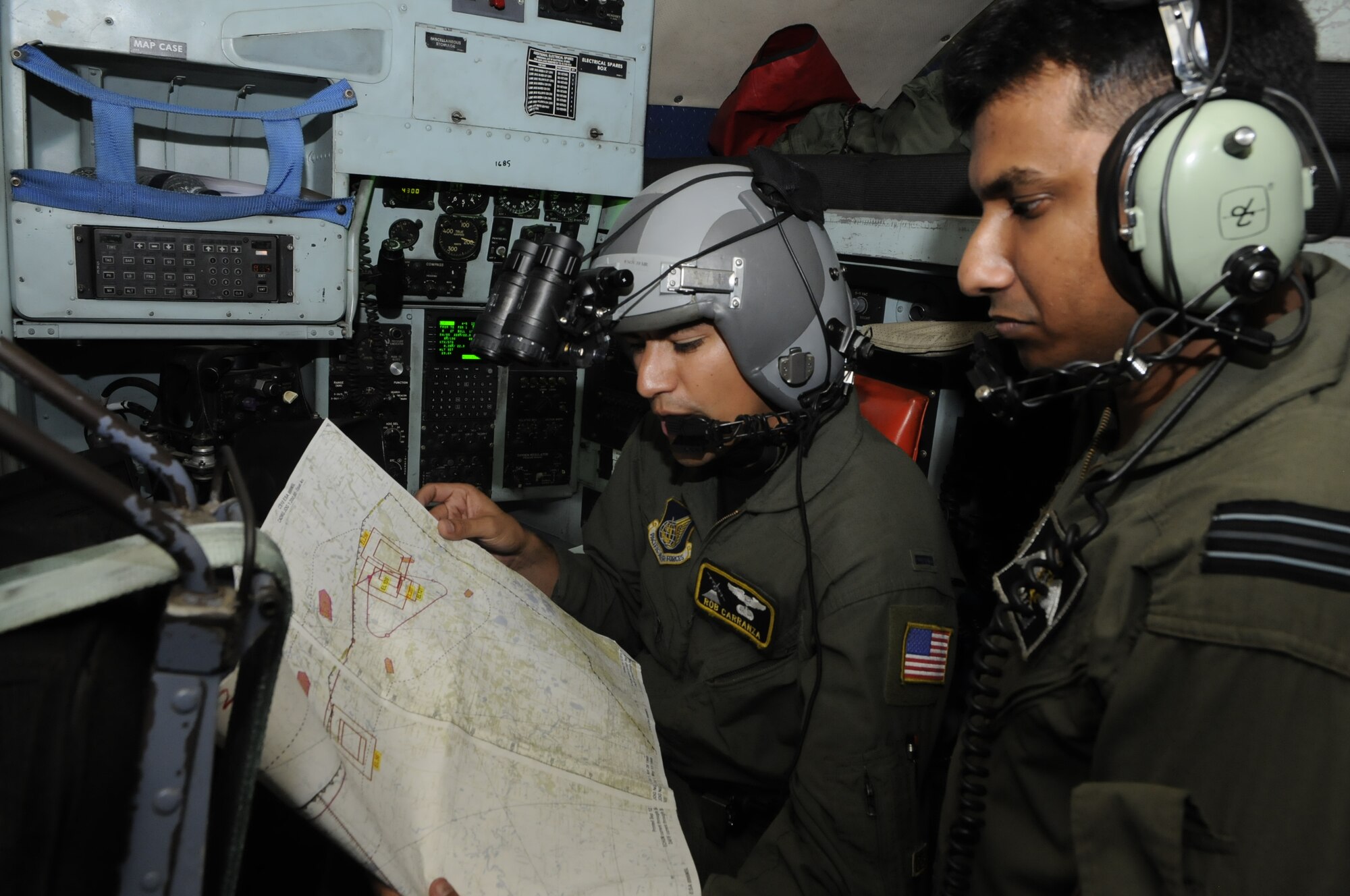 First Lt. Robert Carranza, a navigator from the 36th Airlift Squadron at Yakota Air Base, Japan, goes over route points with Bangladesh Flt. Lt. Salem, a co-pilot, during a flight to Sylhet, Bangladesh, during exercise Cope South 10, Sept. 22, 2010. The bilateral exercise's subject-matter expert exchanges in maintenance, operations and rigging disciplines strengthen the strong and growing partnership between the United States and Bangladesh. Two C-130s from Yokota Air Base, Japan, and an AN-32 from Kurmitola Air Base participated in Cope South 10. (U.S. Air Force photo/ Master Sgt. Jeff Loftin)
