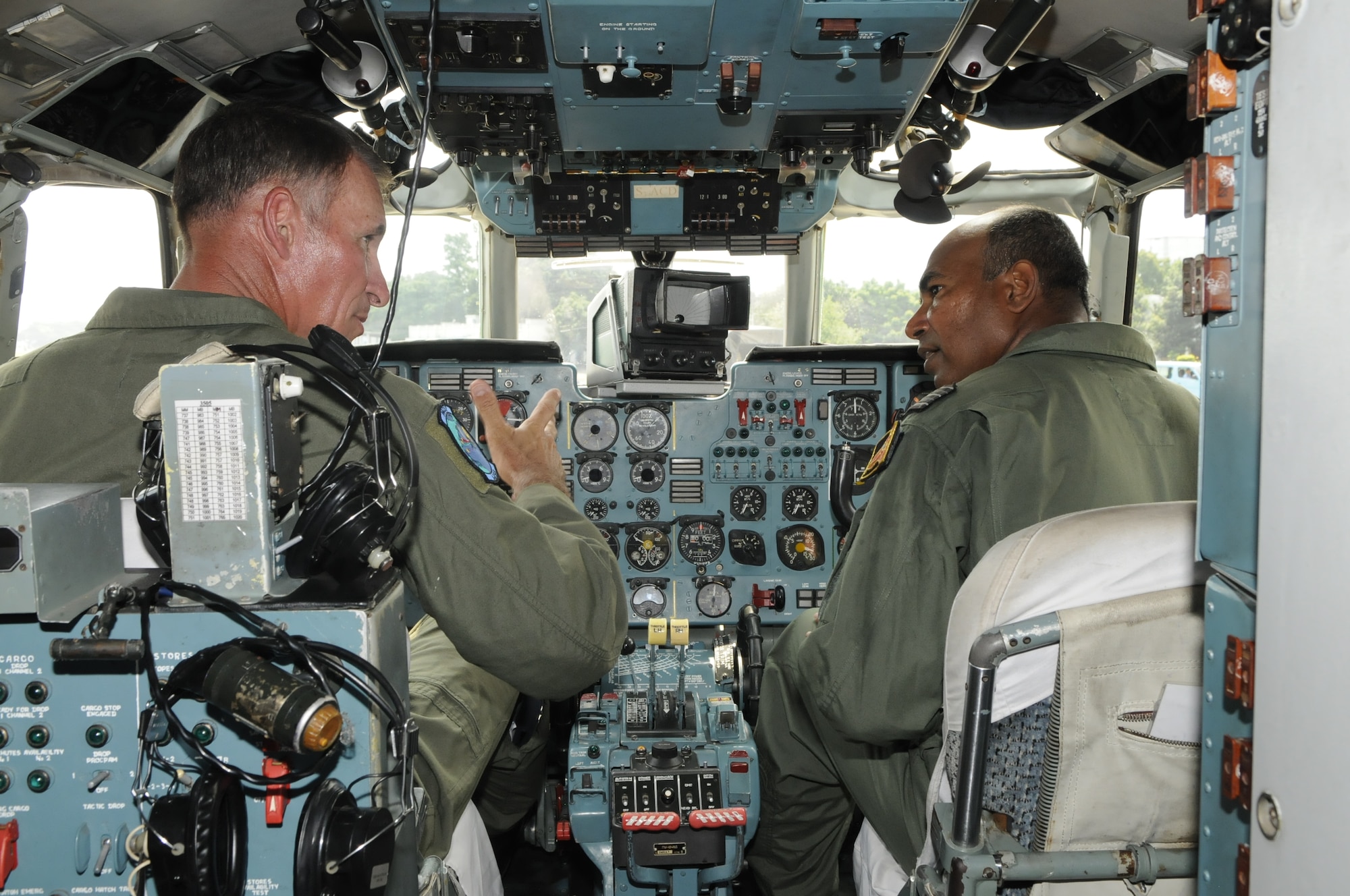 Brig. Gen. Michael Keltz, Pacific Air Forces director of operations, plans, programs and requirements at Joint Base Pearl Harbor Hickam, Hawaii, discusses the differences between the C-130 Hercules and AN-32 aircraft with Bangladesh Wing Commander Imran while in an AN-32 cockpit at the close of exercise Cope South 10, on Sept. 23, 2010. The exercise offered 40 Airmen from Yokota Air Base, Japan, the opportunity to exchange airlift, air land and airdrop delivery techniques with the Bangladesh Air Force. Two C-130s from Yokota Air Base, Japan, and an AN-32 from Kurmitola Air Base participated in Cope South 10. (U.S. Air Force photo/ Master Sgt. Jeff Loftin)