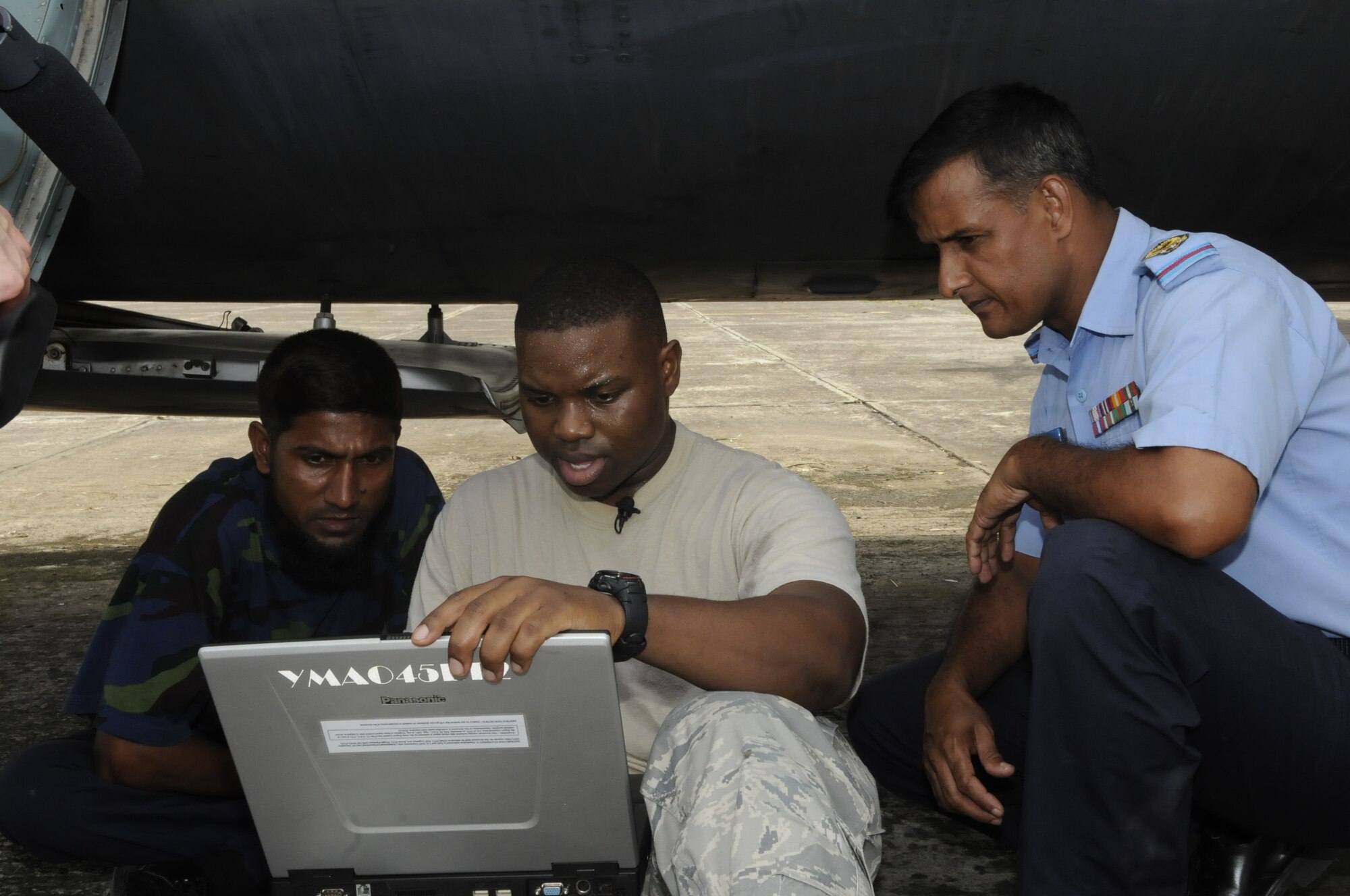 Staff Sgt. Christopher Smith, an aircraft mechanic from the 374th Aircraft Maintenance Squadron at Yakota Air Base, Japan, helps Bangladesh Air Force Sgt. Halim and Warrant Officer Malek find a solution to a circuit breaker problem on their
C-130 Hercules aircraft during exercise Cope South 10, on Sept. 22, 2010. The
bilateral exercise's subject matter expert exchanges in maintenance,
operations and rigging disciplines strengthen the strong and growing
partnership between the United States and Bangladesh. Two C-130s from Yokota
Air Base, Japan, and an AN-32 from Kurmitola Air Base particpated in Cope
South 10. (U.S. Air Force photo/ Master Sgt. Jeff Loftin)