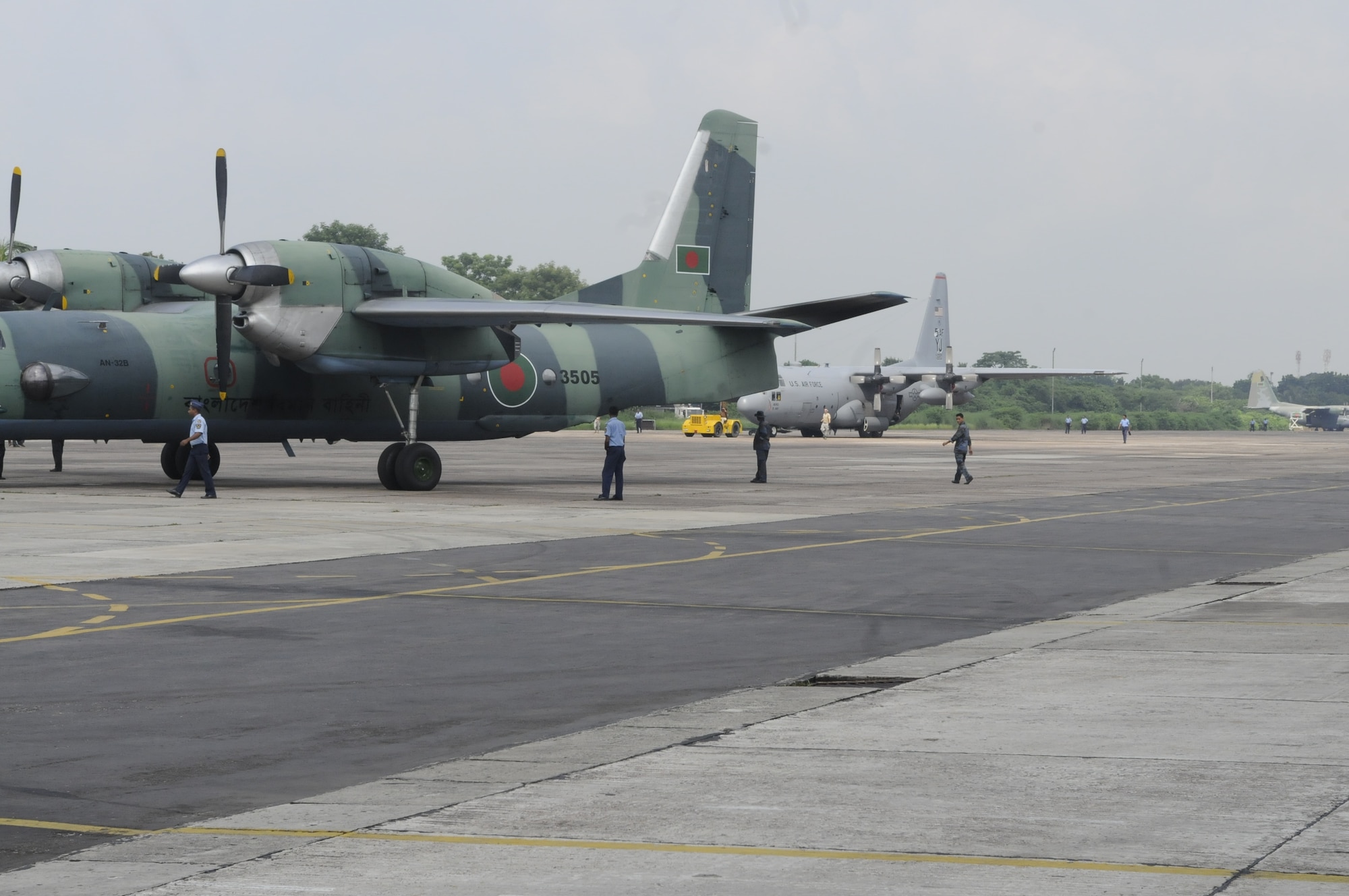 A U.S. C-130 Hercules aircraft is towed near a Bangladesh AN-32 aircraft on the Kurmitola Air Base flightline, Bangladesh, during exercise Cope South 10, on Sept. 23, 2010. The exercise offered 40 Airmen from Yokota Air Base, Japan, the opportunity to exchange airlift, air land and airdrop delivery techniques with the Bangladesh Air
Force. Two C-130s from Yokota Air Base, Japan, and an AN-32 from Kurmitola
Air Base participated in Cope South 10. (U.S. Air Force photo/ Master Sgt. Jeff Loftin)