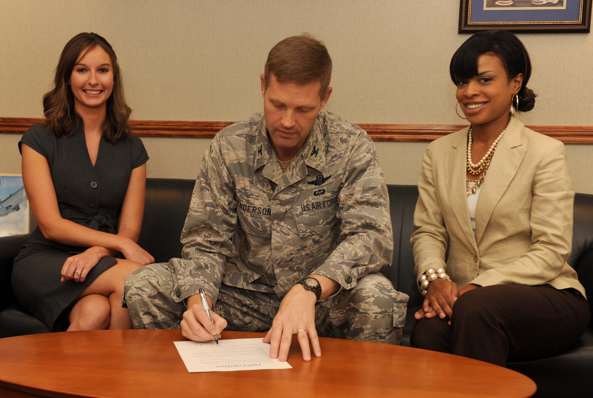 MOODY AIR FORCE BASE, Ga. -- Col. Gary Henderson, 23rd Wing commander, signs the Community Planning Month proclamation with Becki Lopez (right), 23rd Civil Engineering Squadron environmental planner and Diondra Nicholas (left), 23rd Civil Engineering Squadron community planner, here Sept. 22. The proclamation declared that October will become Moody’s Community Planning Month. (U.S. Air Force photo/Airman 1s t Class Benjamin Wiseman)