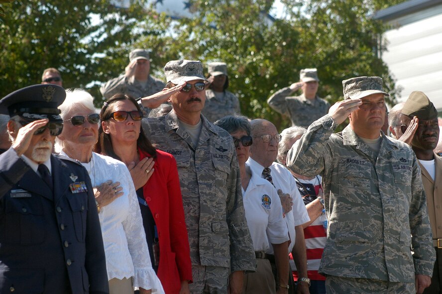 People stand during the playing of Taps at the POW/MIA Recognition Day ceremony. U. S. Air Force photo by Sue Sapp  