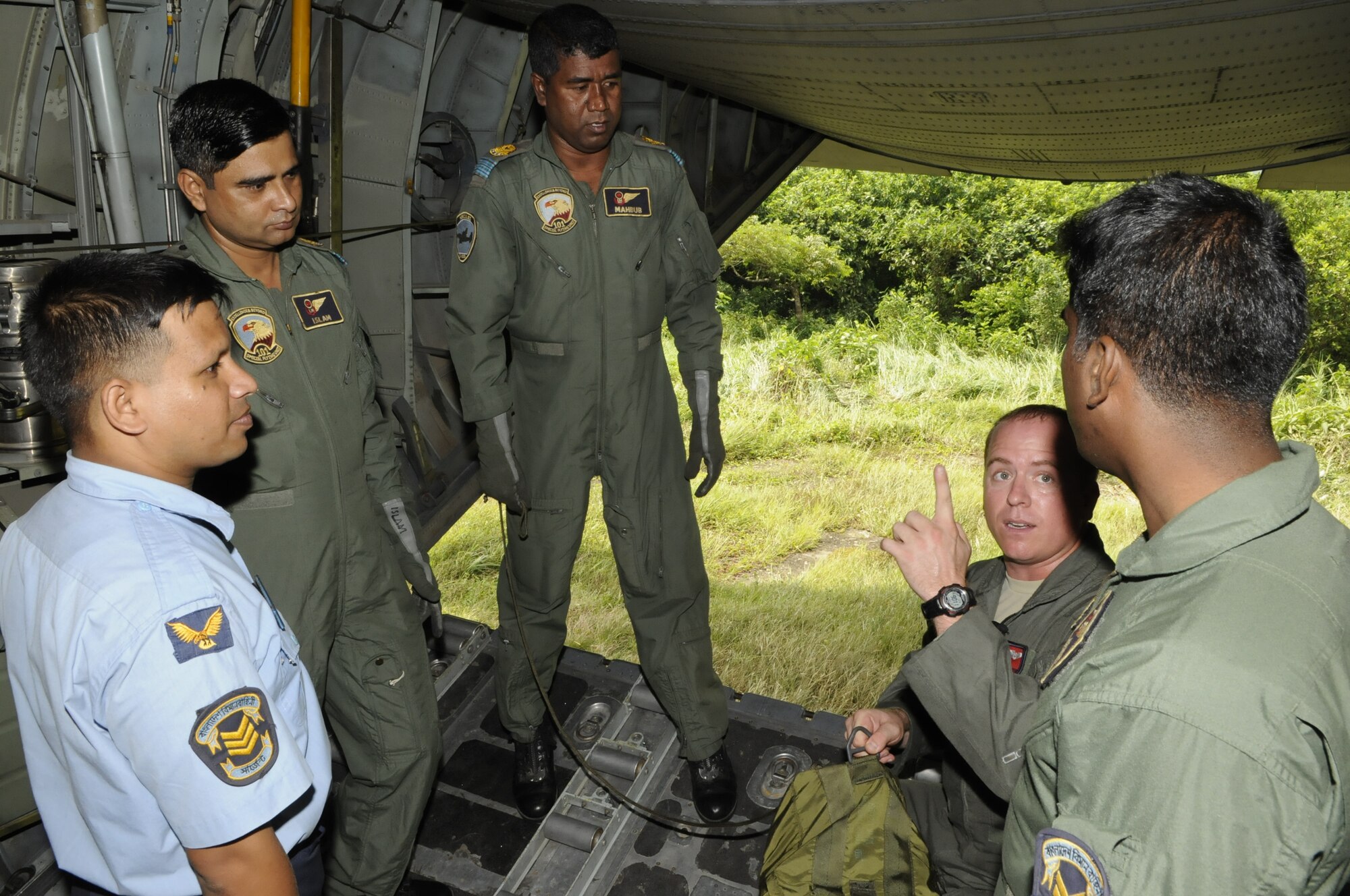Staff Sgt. Jace Hartog, a loadmaster from the 36th Airlift Squadron at Yakota Air Base, Japan, shows Bangladesh loadmasters how to rig an extraction parachute in the bomb rack of a U.S. C-130 Hercules during exercise Cope South 10, on Sept. 22, 2010. The bilateral exercise's subject matter expert exchanges in maintenance, operations and rigging disciplines strengthen the strong and growing partnership between the United States and Bangladesh. Two C-130s from Yokota Air Base, Japan, and an AN-32 from
Kurmitola Air Base participated in Cope South 10. (U.S. Air Force photo/ Master Sgt. Jeff Loftin)