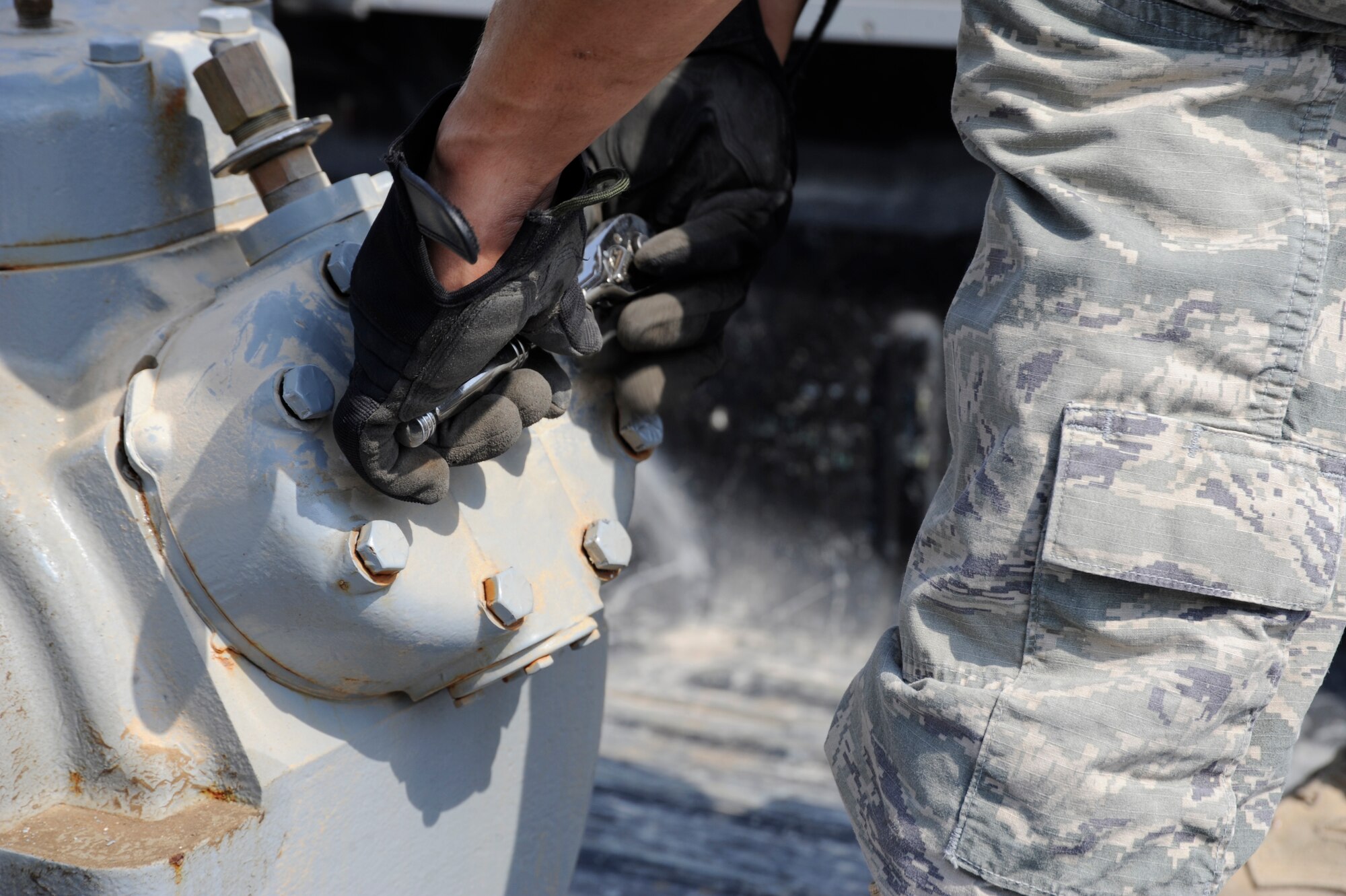 Senior Airman Mathew Bright, 380th Expeditionary Civil Engineer Squadron heating ventilation and air conditioning technician, works on an air conditioner compressor Sept. 23, 2010 at an undisclosed location in Southwest Asia. (U.S. Air Force photo/Tech. Sgt. April Wickes)