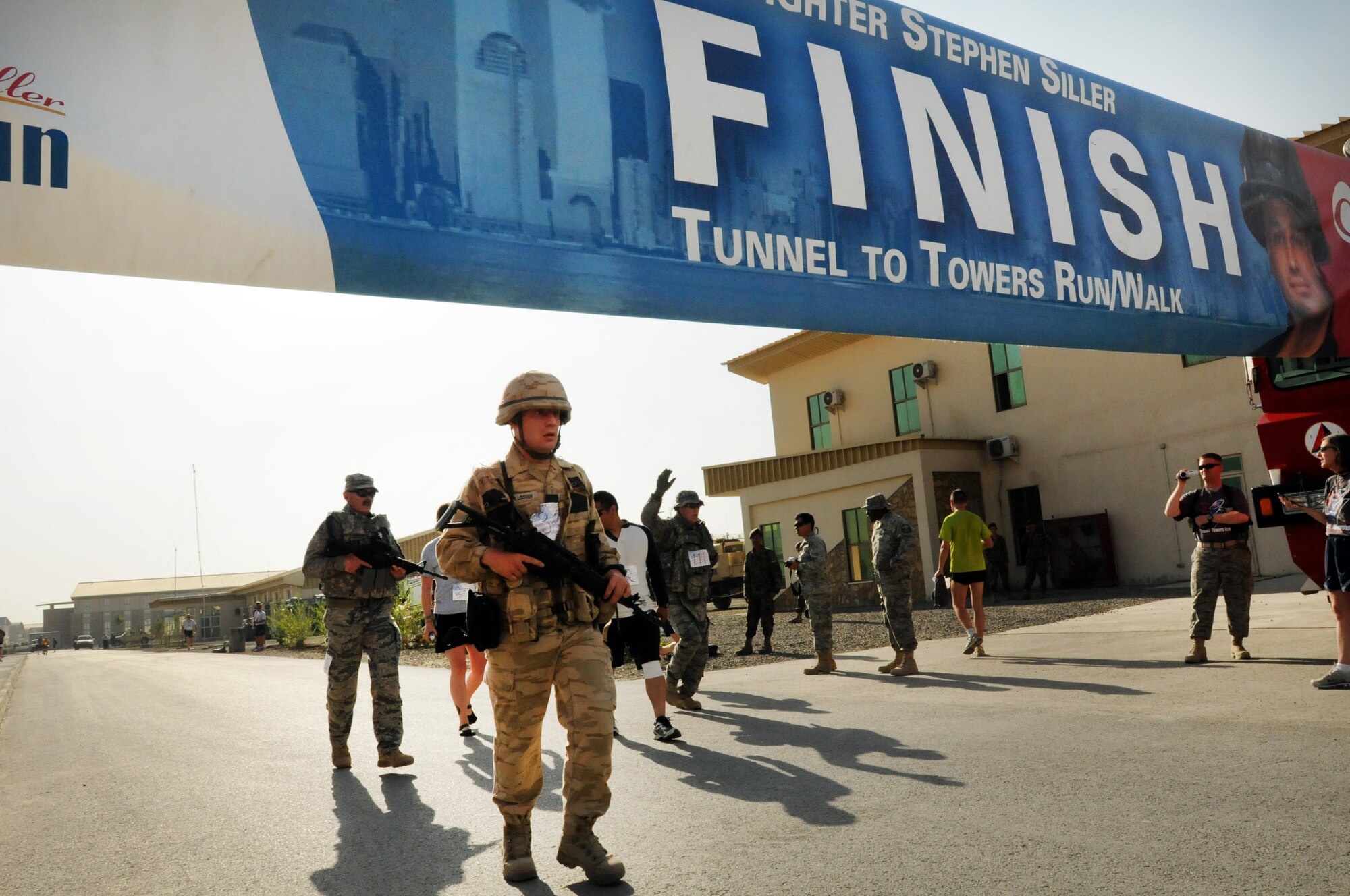 100924-N-6031Q-009 KABUL, Afghanistan - NATO Air Training Command- Afghanistan personnel alongside NATO and civilian partners participate in the "Tunnel to Towers run/walk race on Sep. 24, 2010. The race was held on the International Security Assistance Force and Afghan Air Force base in Kabul, Afghanistan. The race is to commemorate the arduous run made by New York City Firefighter Stephen Siller, who during the events of 9/11 picked up his gear weighing 75 pounds and ran to the twin towers nearly three miles away and perished alongside his fellow firefighters in the attempt to save lives. After the race a piece of steel was placed in a memorial on the grounds of the AAF base where it will stay until the last American leaves Afghanistan. (US Navy photo by Mass Communication Specialist 2nd Class David Quillen/ RELEASED).