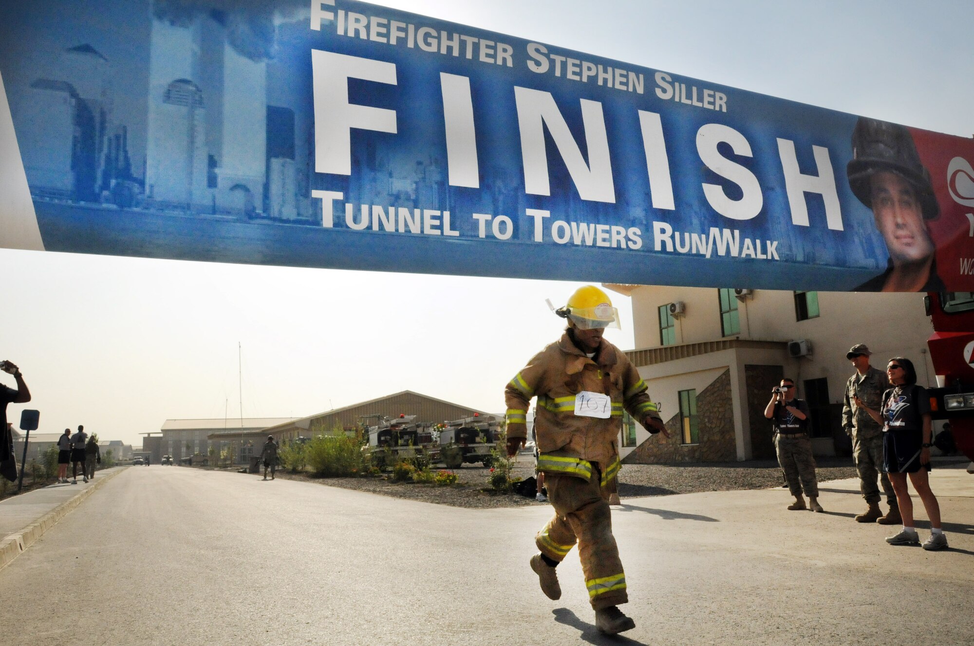 100924-N-6031Q-008 KABUL, Afghanistan - NATO Air Training Command- Afghanistan personnel alongside NATO and civilian partners participate in the "Tunnel to Towers run/walk race on Sep. 24, 2010. The race was held on the International Security Assistance Force and Afghan Air Force base in Kabul, Afghanistan. The race is to commemorate the arduous run made by New York City Firefighter Stephen Siller, who during the events of 9/11 picked up his gear weighing 75 pounds and ran to the twin towers nearly three miles away and perished alongside his fellow firefighters in the attempt to save lives. After the race a piece of steel was placed in a memorial on the grounds of the AAF base where it will stay until the last American leaves Afghanistan. (US Navy photo by Mass Communication Specialist 2nd Class David Quillen/ RELEASED).