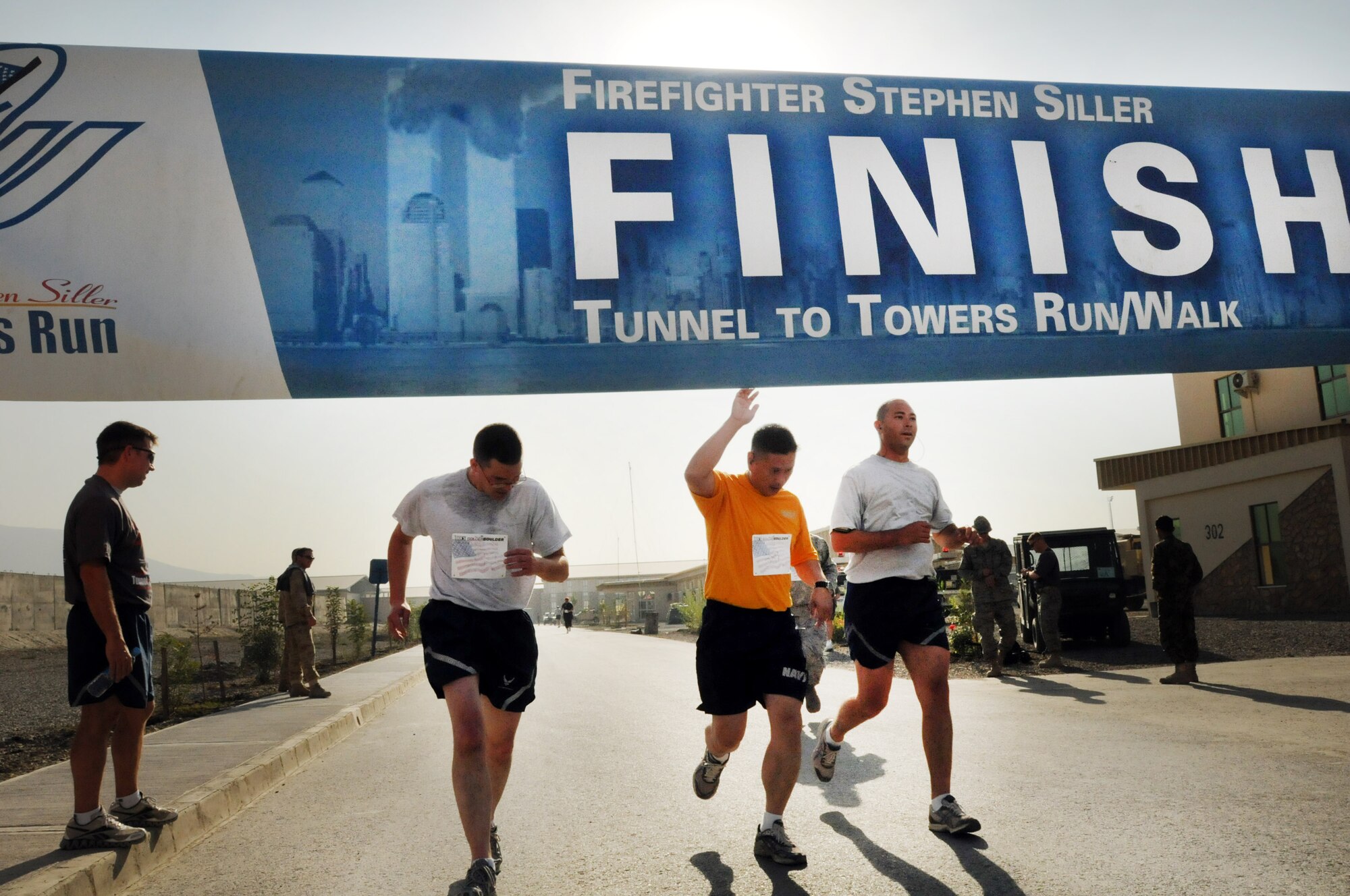 100924-N-6031Q-007 KABUL, Afghanistan - NATO Air Training Command- Afghanistan personnel alongside NATO and civilian partners participate in the "Tunnel to Towers run/walk race on Sep. 24, 2010. The race was held on the International Security Assistance Force and Afghan Air Force base in Kabul, Afghanistan. The race is to commemorate the arduous run made by New York City Firefighter Stephen Siller, who during the events of 9/11 picked up his gear weighing 75 pounds and ran to the twin towers nearly three miles away and perished alongside his fellow firefighters in the attempt to save lives. After the race a piece of steel was placed in a memorial on the grounds of the AAF base where it will stay until the last American leaves Afghanistan. (US Navy photo by Mass Communication Specialist 2nd Class David Quillen/ RELEASED).